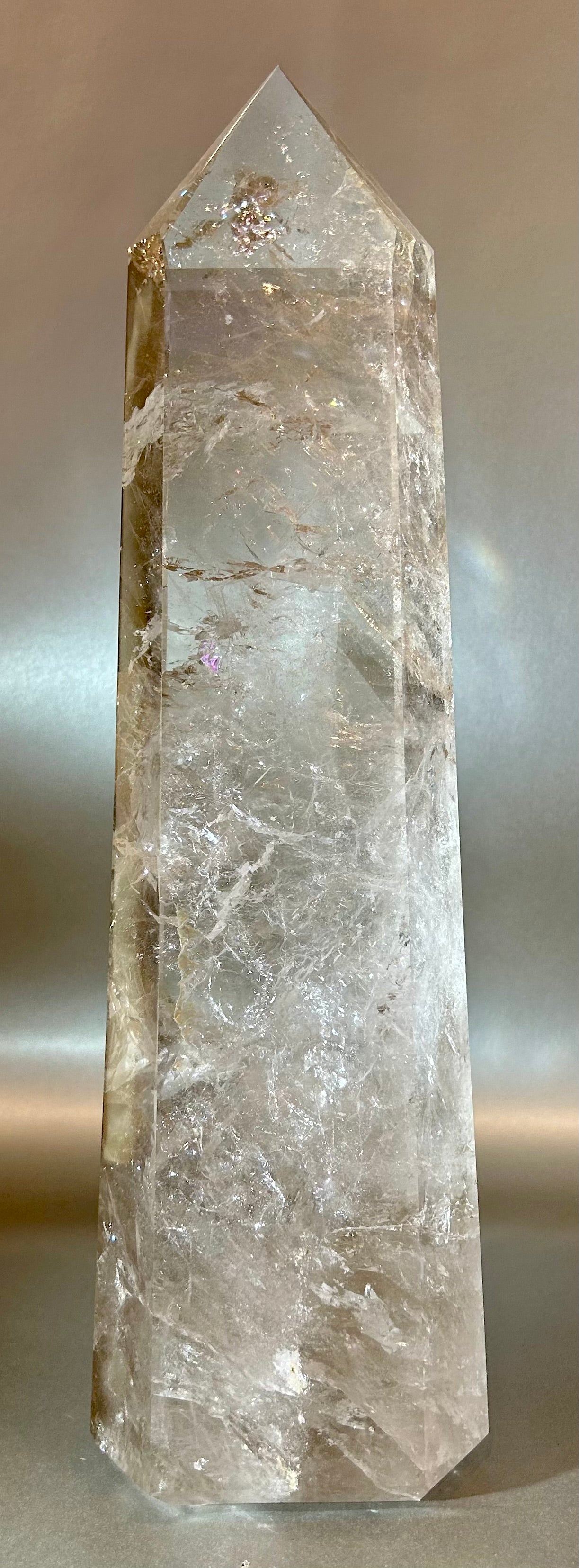 Introducing the Smokey Quartz Tower - a quartz crystal tower for the discerning collector. Standing tall and proud, its large size makes a statement in any space. A stunning addition to your home, this tower exudes elegance and refinement, a true work of art.Measures approx. 4"W x 2.5"D x 14"H. Smokey Quartz Tower