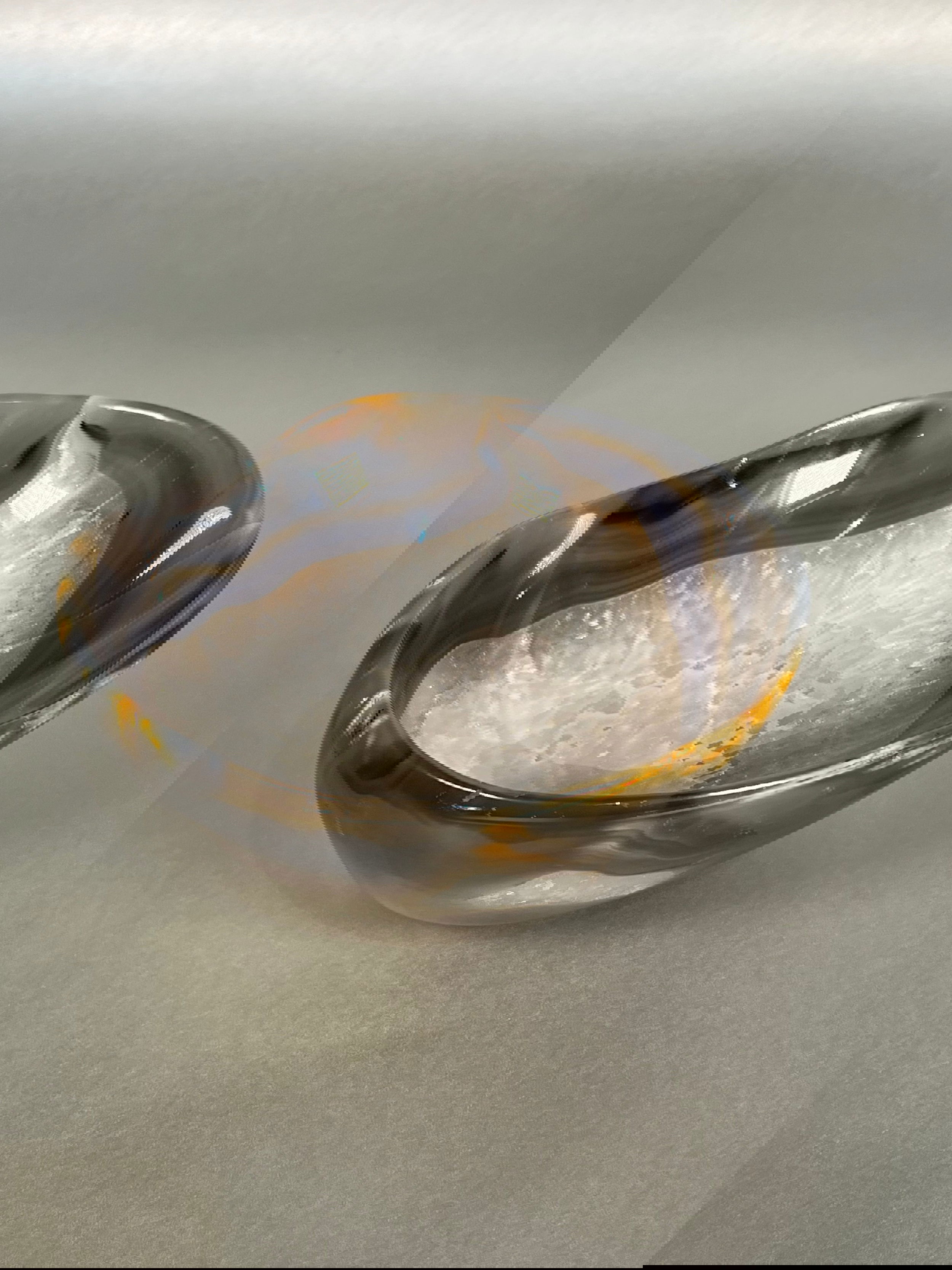 Indulge in the exquisite beauty of our Agate Freeform Bowl. Crafted from stunning multicolored agate, this unique bowl features a freeform design that adds a touch of artistry to any space.Approx. 3" x 6.5" Agate Freeform Bowl