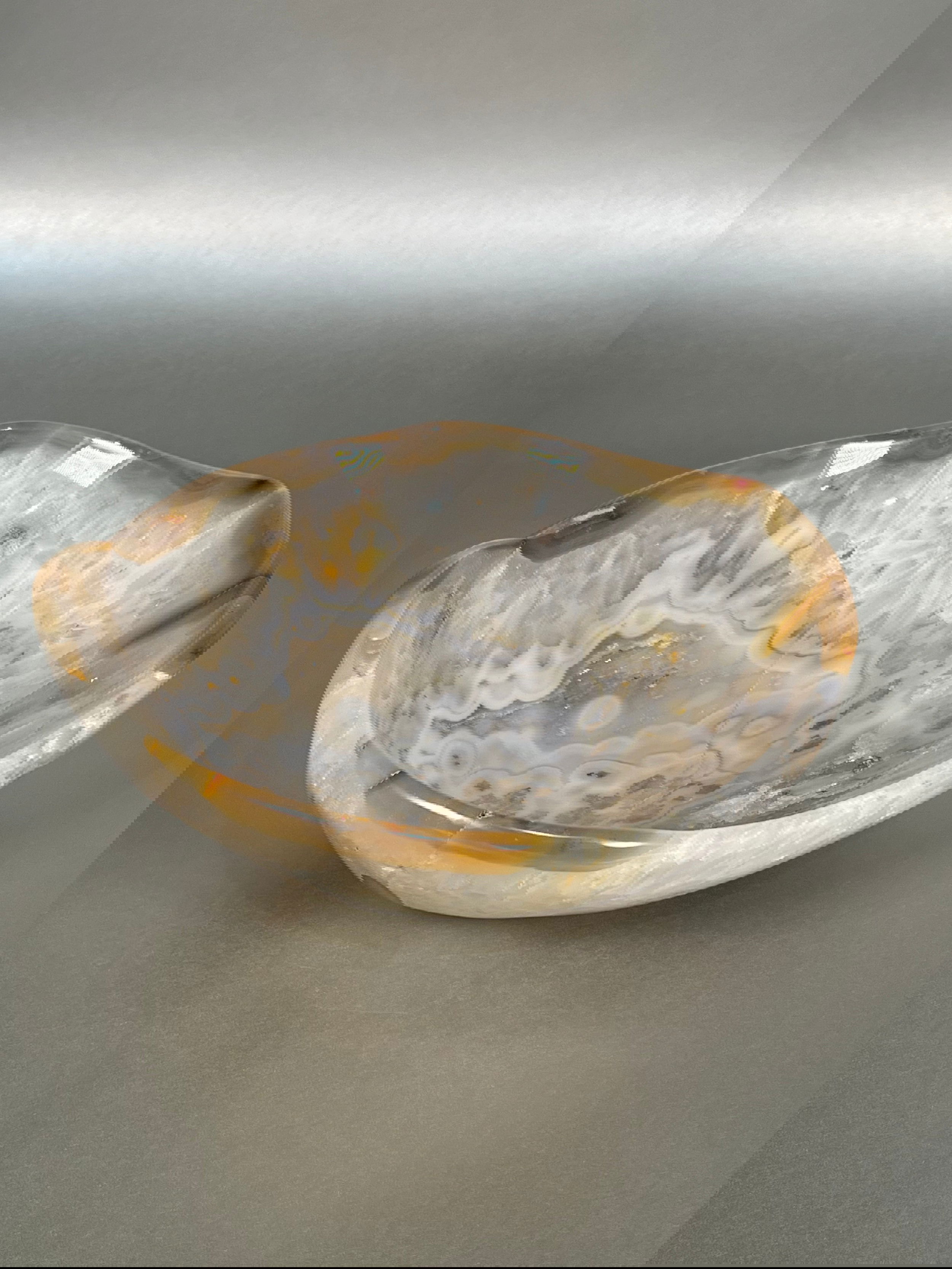 Indulge in the exquisite beauty of our Agate Freeform Bowl. Crafted from stunning multicolored agate, this unique bowl features a freeform design that adds a touch of artistry to any space.Approx. 3.25" x 8" Agate Freeform Bowl