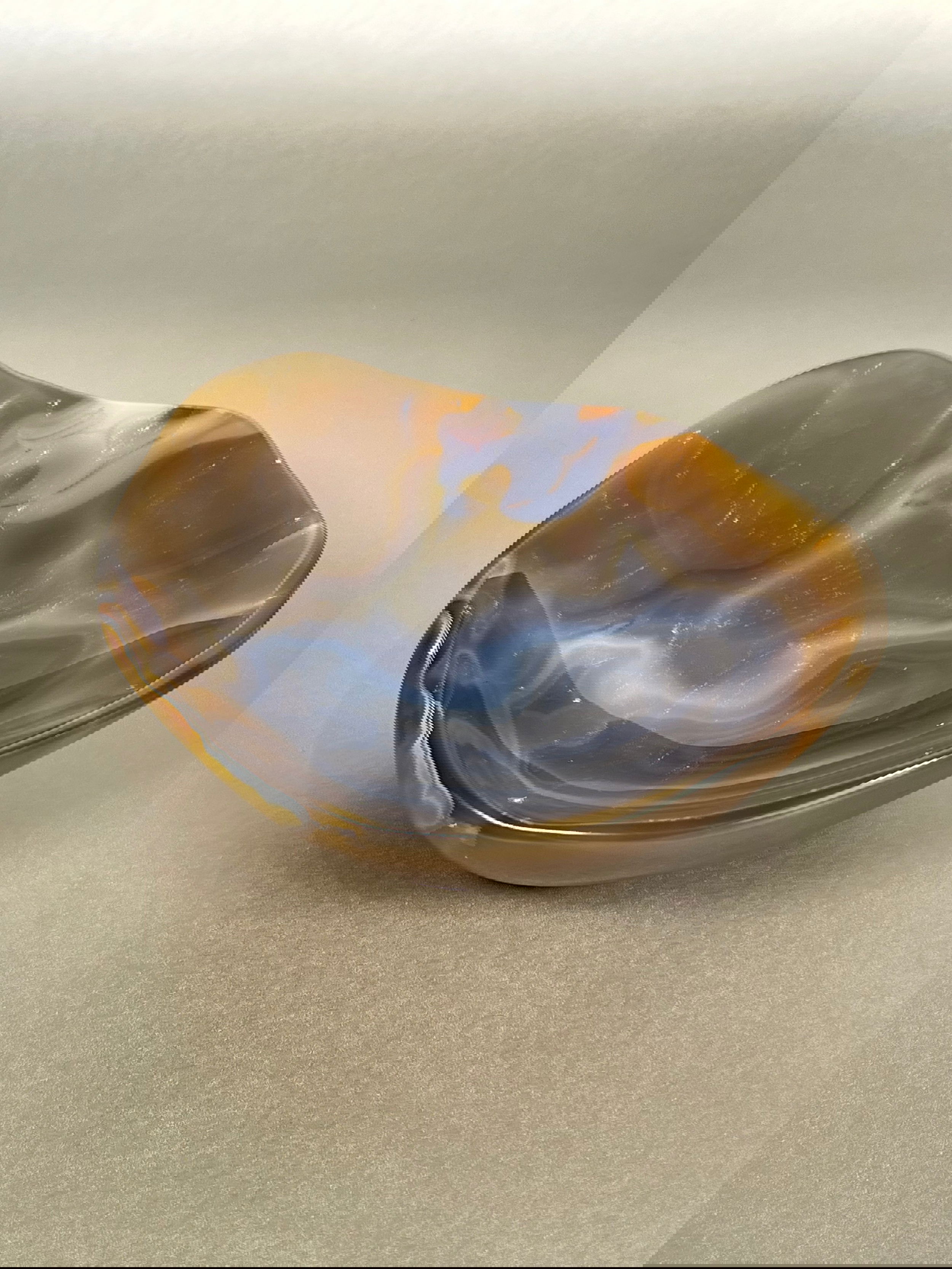 Indulge in the exquisite beauty of our Agate Freeform Bowl. Crafted from stunning multicolored agate, this unique bowl features a freeform design that adds a touch of artistry to any space.Approx. 2.5" x 7" Agate Freeform Bowl