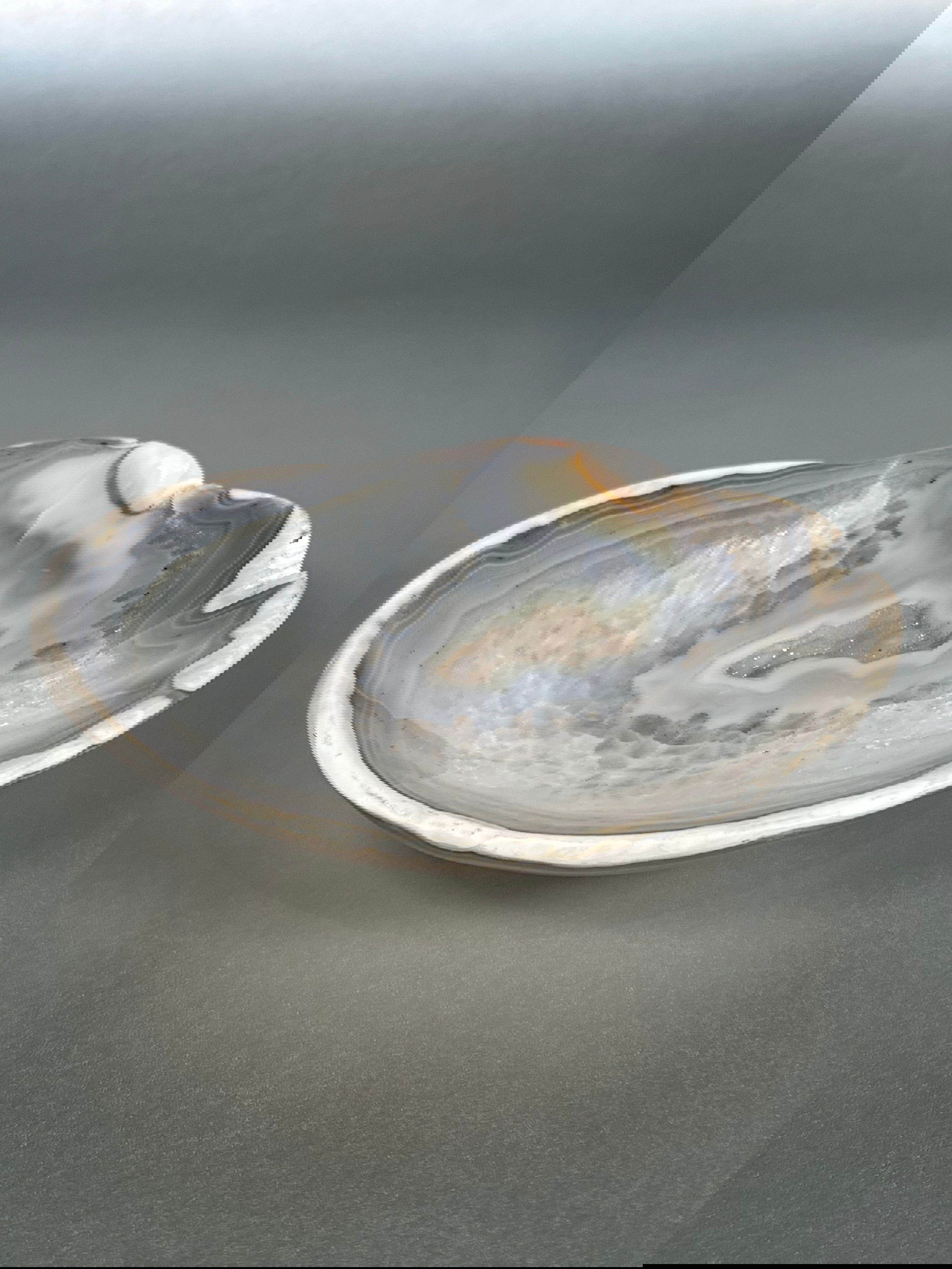 Indulge in the exquisite beauty of our Agate Freeform Bowl. Crafted from stunning multicolored agate, this unique bowl features a freeform design that adds a touch of artistry to any space.Approx. 1.5" x 6" Agate Freeform Bowl
