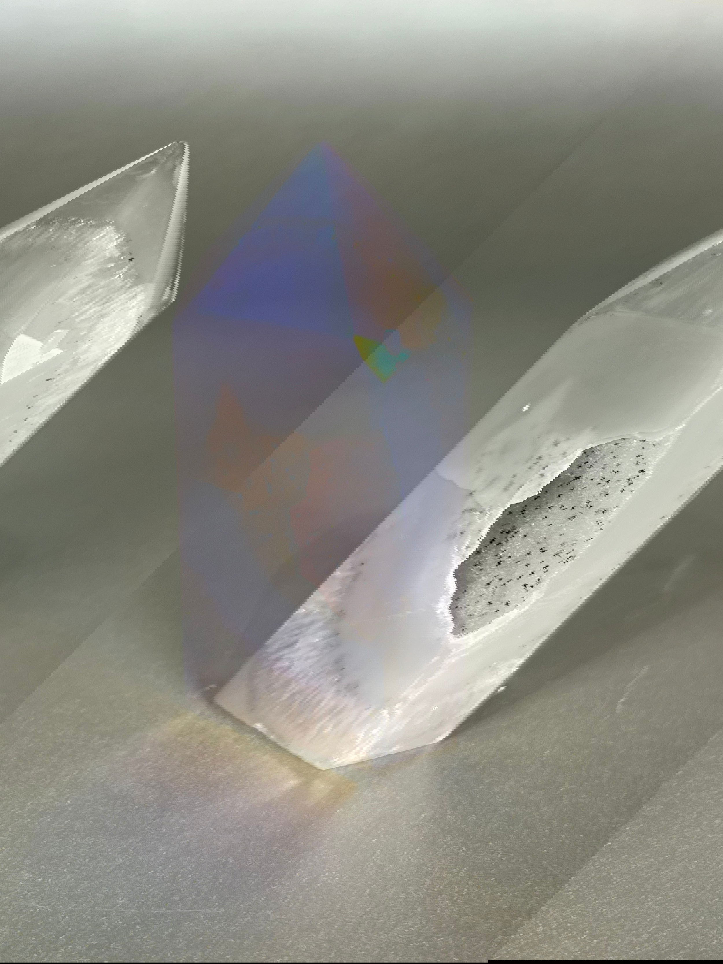 Experience the dreamy elegance of our Aura Agate Obelisk. Each one is uniquely crafted to exude a sense of luxury and exclusivity. Featuring the rare Aura Agate stone, this obelisk brings a touch of sophistication and beauty to any space. Elevate your decor with this truly one-of-a-kind piece. Approx. 3" Tall Aura Agate Tower