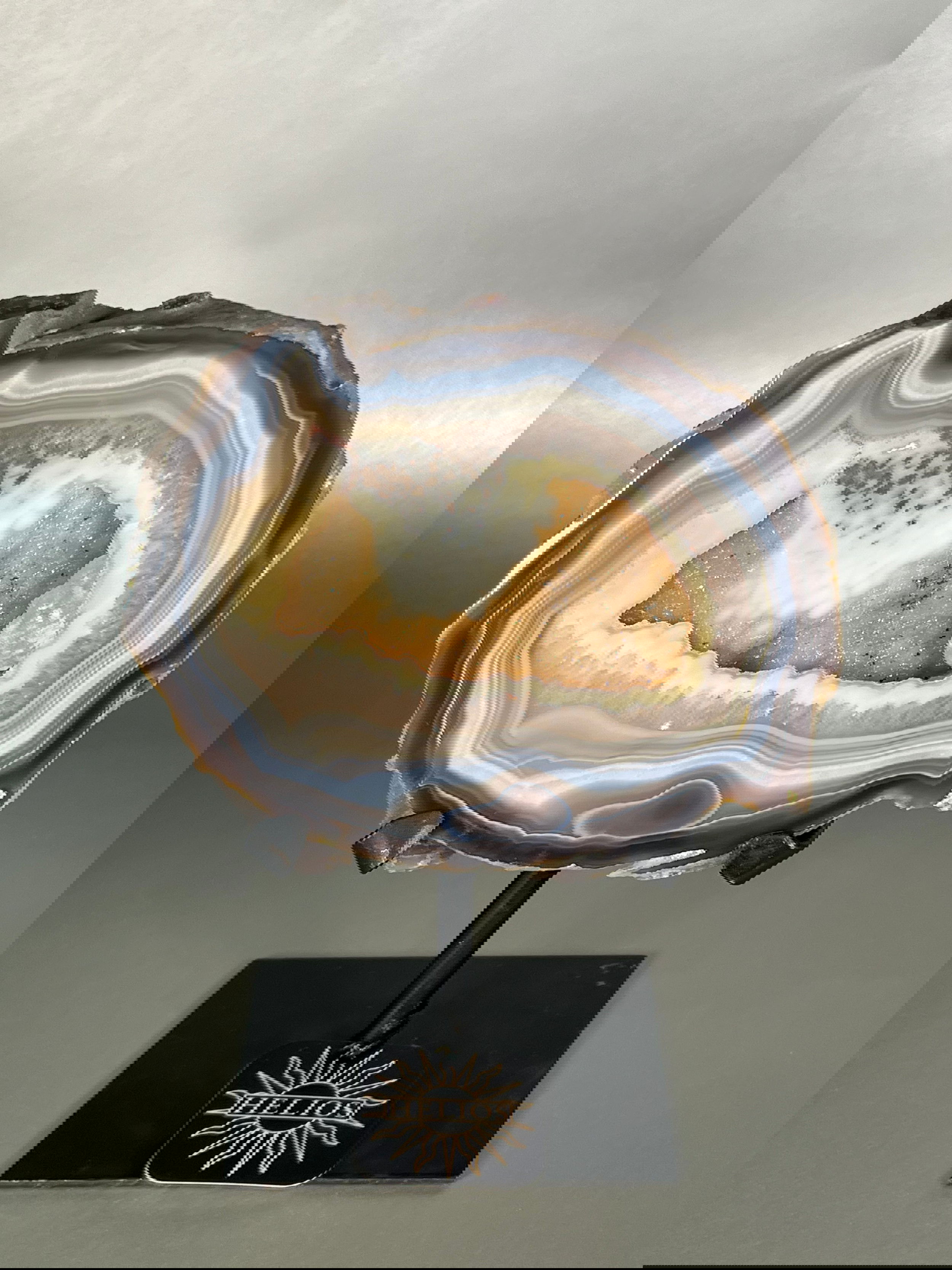 Experience the tranquility of nature with our unique Agate Geodes. These raw pieces are as one-of-a-kind as the natural world itself. Let the serene energy of these stunning agate geodes bring a touch of exclusivity to your decor.Approx. 9" Tall Agate Geode on Stand