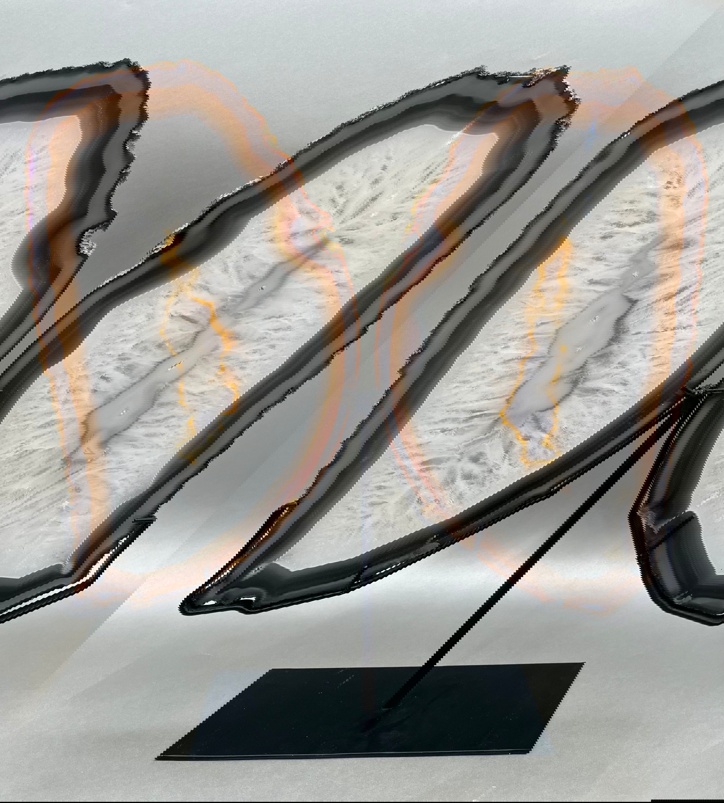Adorned with grace and delicacy, These multicolored Agate Slices elegantly mimic wings of a butterfly, presented atop custom-made supports. Measuring at approx. 13" x 7.5" per "wing". Butterfly Agate Slices