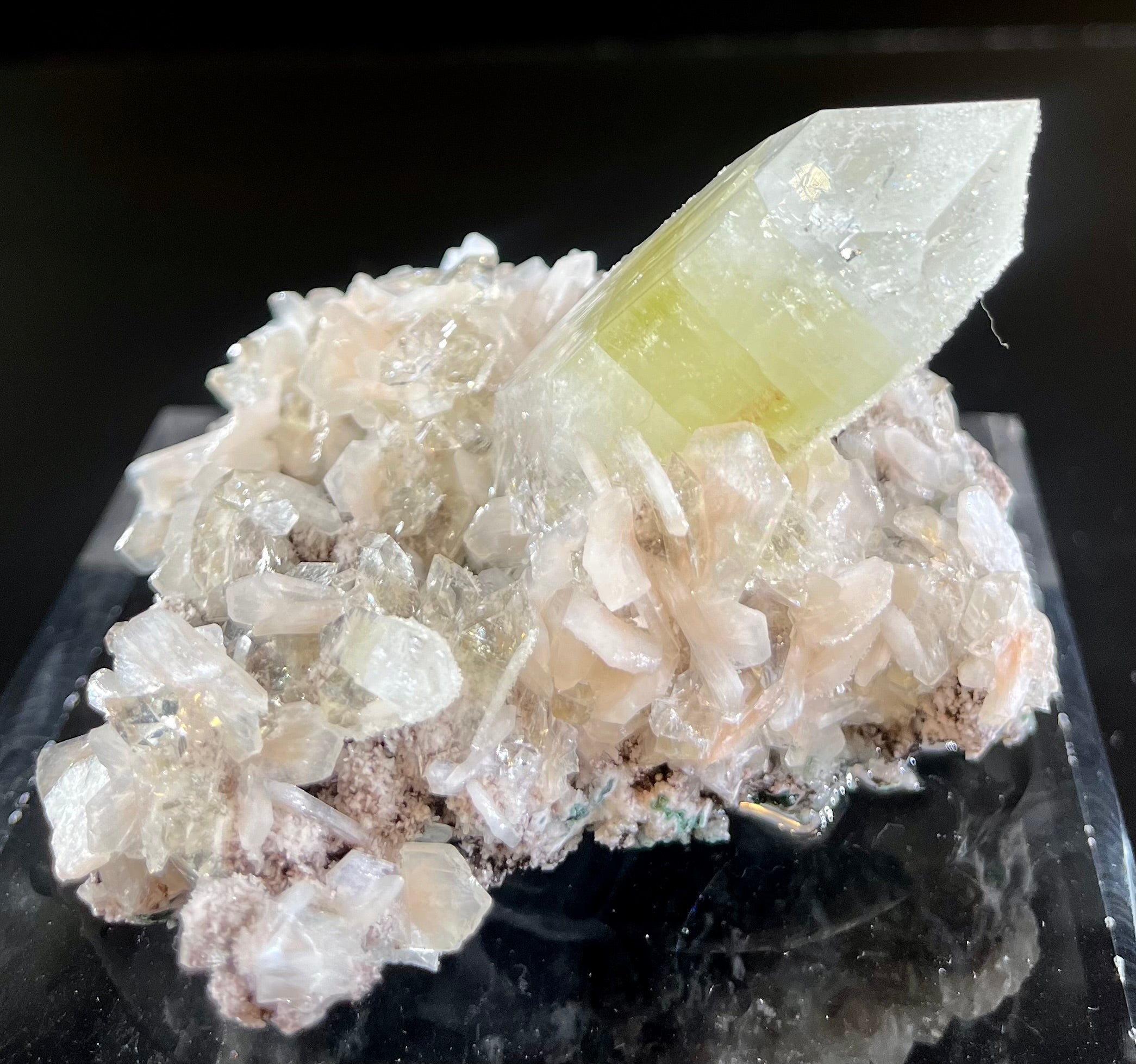 Adorn your space with the refined beauty of this Apophyllite and Stilbite on Chalcedony specimen mineral. Boasting a unique aesthetic, this luxurious piece will give your interior a touch of elegance and sophistication. Ideal for the discerning collector, it's sure to make a stunning addition to your home.Region- Jalgaon District, Maharashtra, IndiaApprox. 2 7/8"H x 3 1/74"W Apophyllite and Stilbite on Chalcedony Mineral Specimen