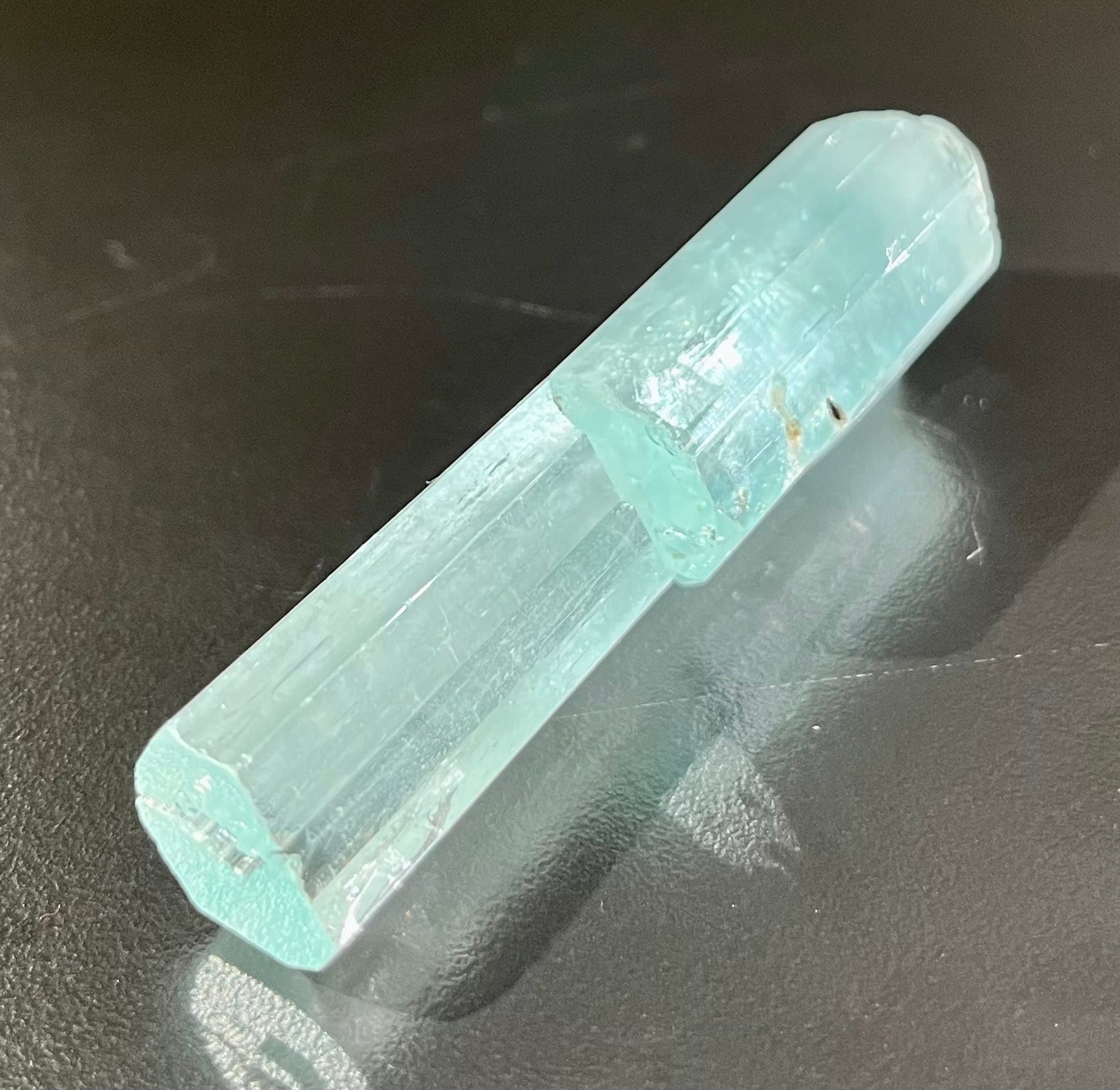 This exquisite aquamarine with spessartine inclusion mineral specimen is an indulgent addition to any collection. Expertly cut to showcase the perfect balance of luster and clarity, its ethereal beauty is further accentuated by the alluring spessartine inclusion within. A luxurious and exclusive piece that begs to be admired.Region- Dassu, Braldu Valley, Baltistan, Gilgit-Baltistan, PakistanApprox. 2 1/2" x 3/4" Aquamarine with Spessartine Mineral Specimen