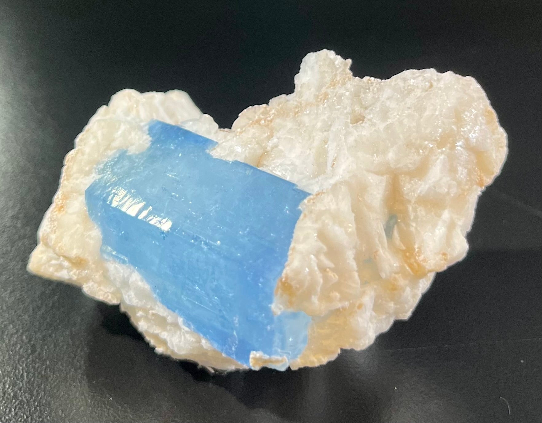 Discover the elegance of Aquamarine on Albite. This extraordinary gemstone features a dazzling aquamarine crystal on a snowy white albite matrix. Every detail of this gemstone is handcrafted with the utmost sophistication and craftsmanship to create a breathtakingly luxurious piece. Elevate your look with this truly exquisite gemstone.Region- Apaligun, Braldu Valley, Gilgit-Baltistan, PakistanApprox. 1 1/2"H x 2"W Aquamarine on Albite Mineral Specimen
