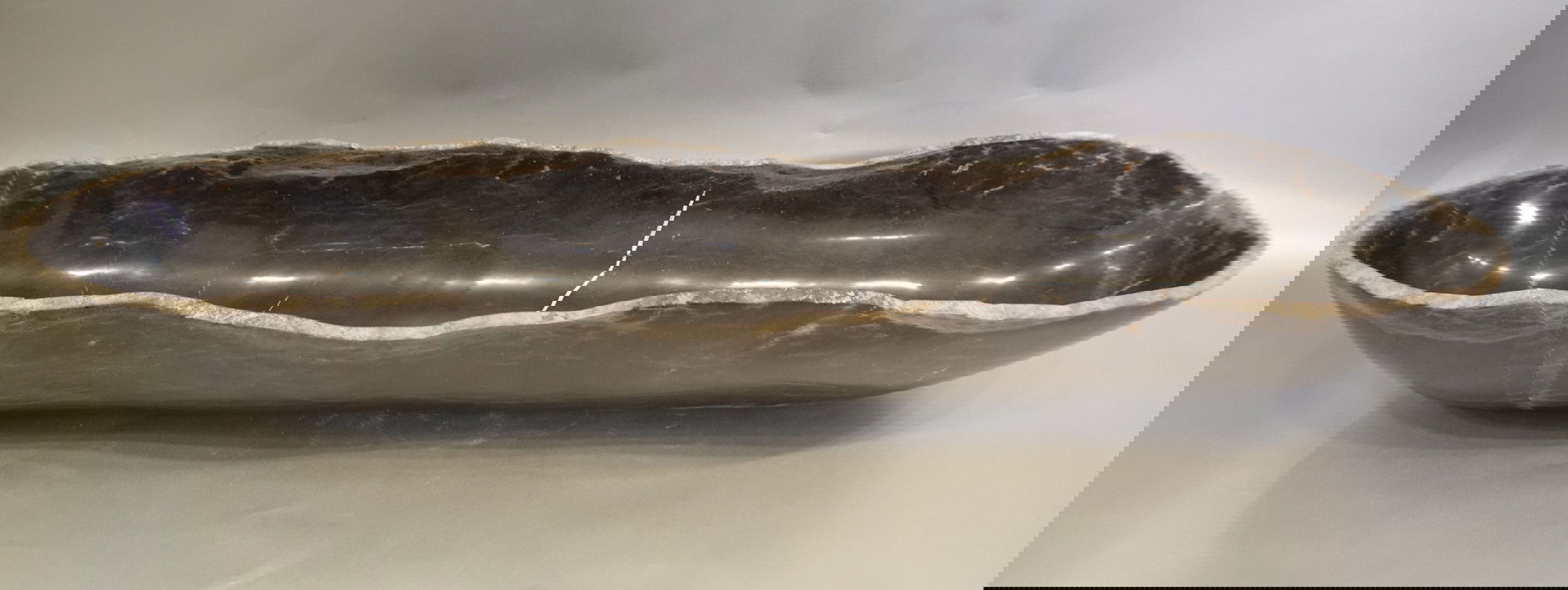 Indulge in the timeless elegance of our Black Onyx Marble Trough. Crafted from luxurious black onyx, each unique piece features stunning marble veins and a freeform shape. The polished finish adds a touch of sophistication to any space. Elevate your home decor with this exquisite addition.Approx. 35.25" x 9" x 4.75" Black Onyx Marble Trough