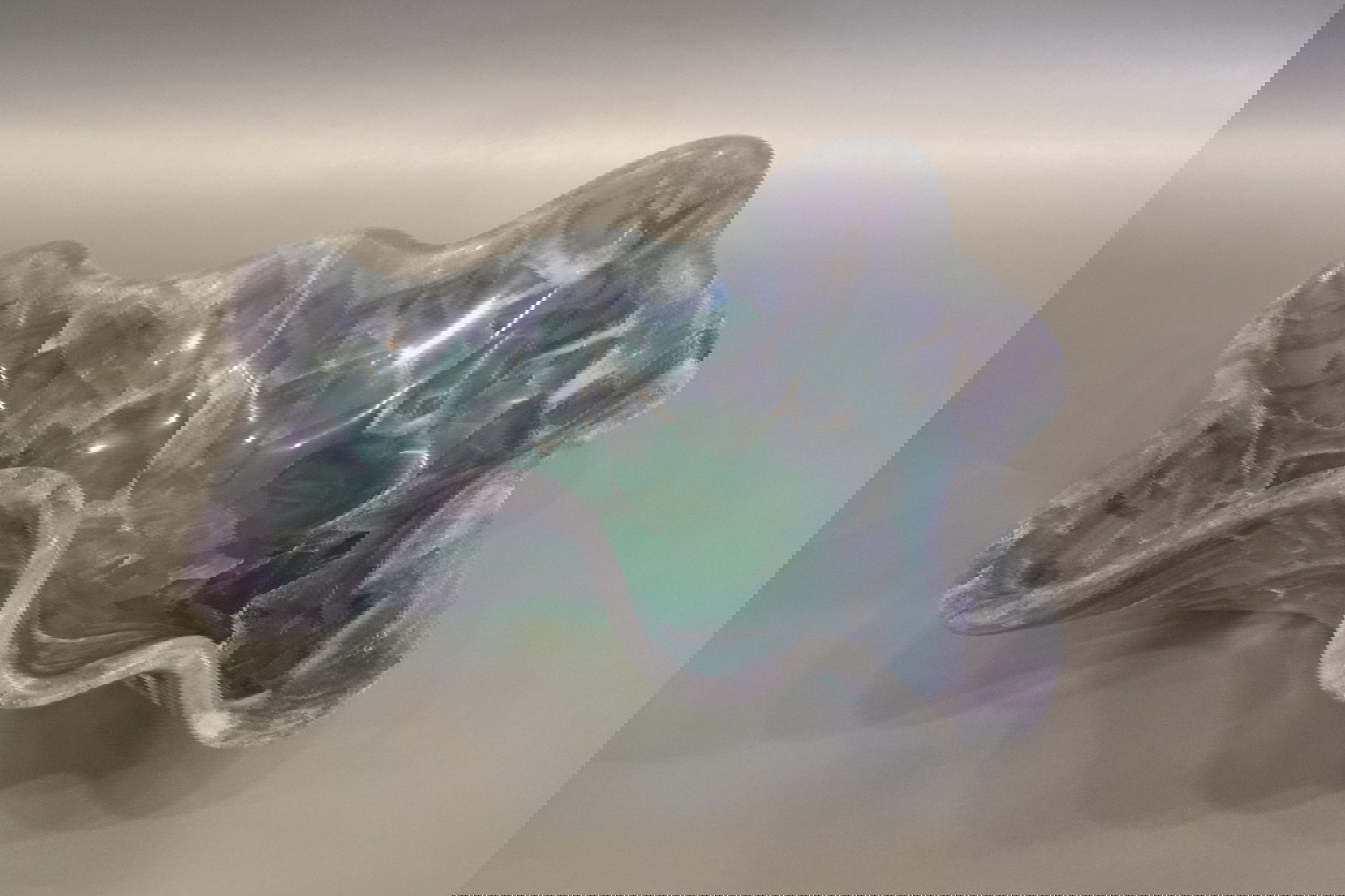 Indulge in luxury with our exquisite Blue Fluorite Bowl. Crafted and carved from the finest blue and purple fluorite, this freeform bowl will add a touch of sophistication to any space. Its unique design and stunning colors make it a true work of art. Elevate your decor with this exclusive piece. Blue Fluorite Bowl