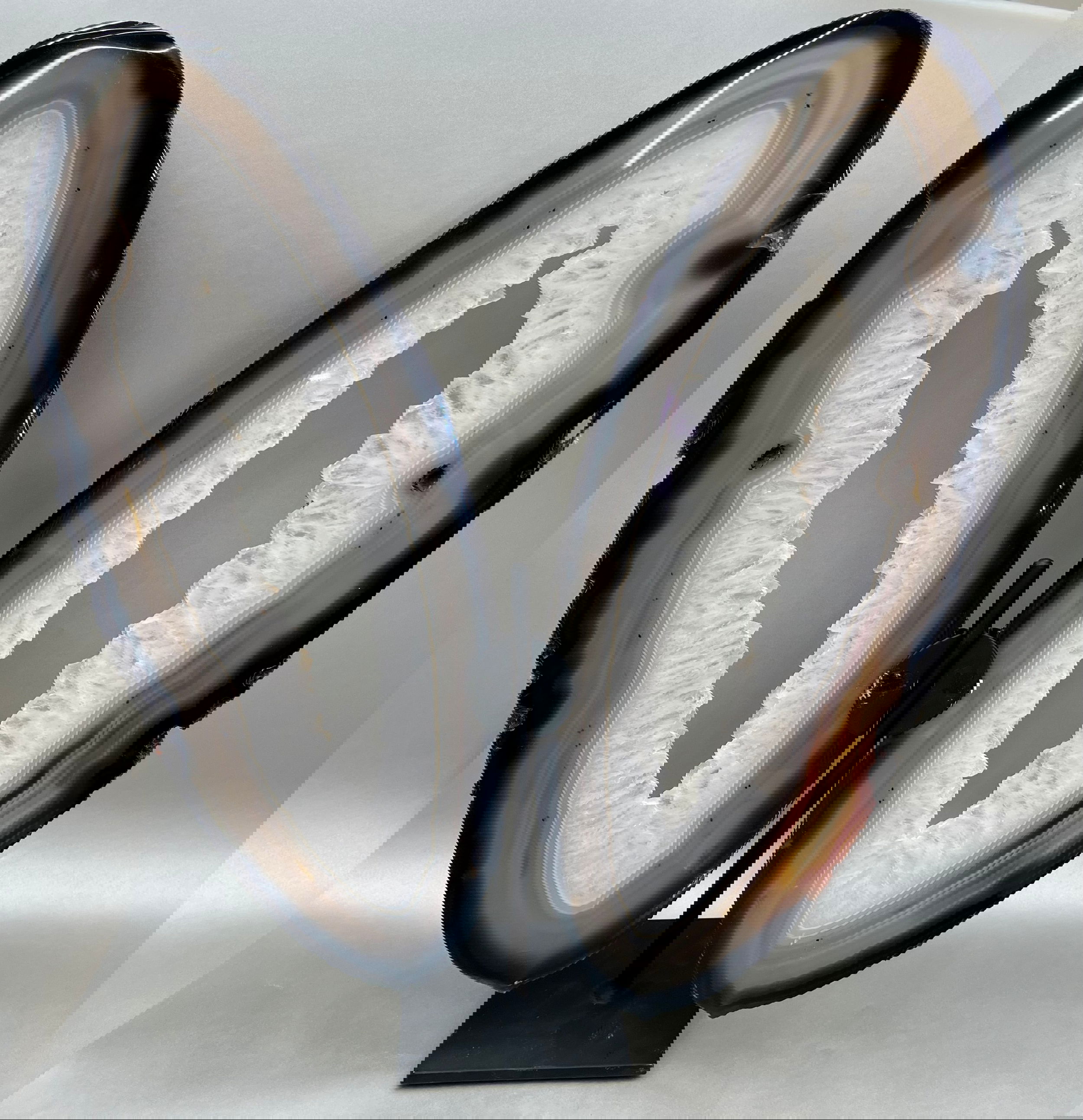 Adorned with grace and delicacy, These multicolored Agate Slices elegantly mimic wings of a butterfly, presented atop custom-made supports. Measuring at approx. 18" x 7" per "wing". Butterfly Agate Slices