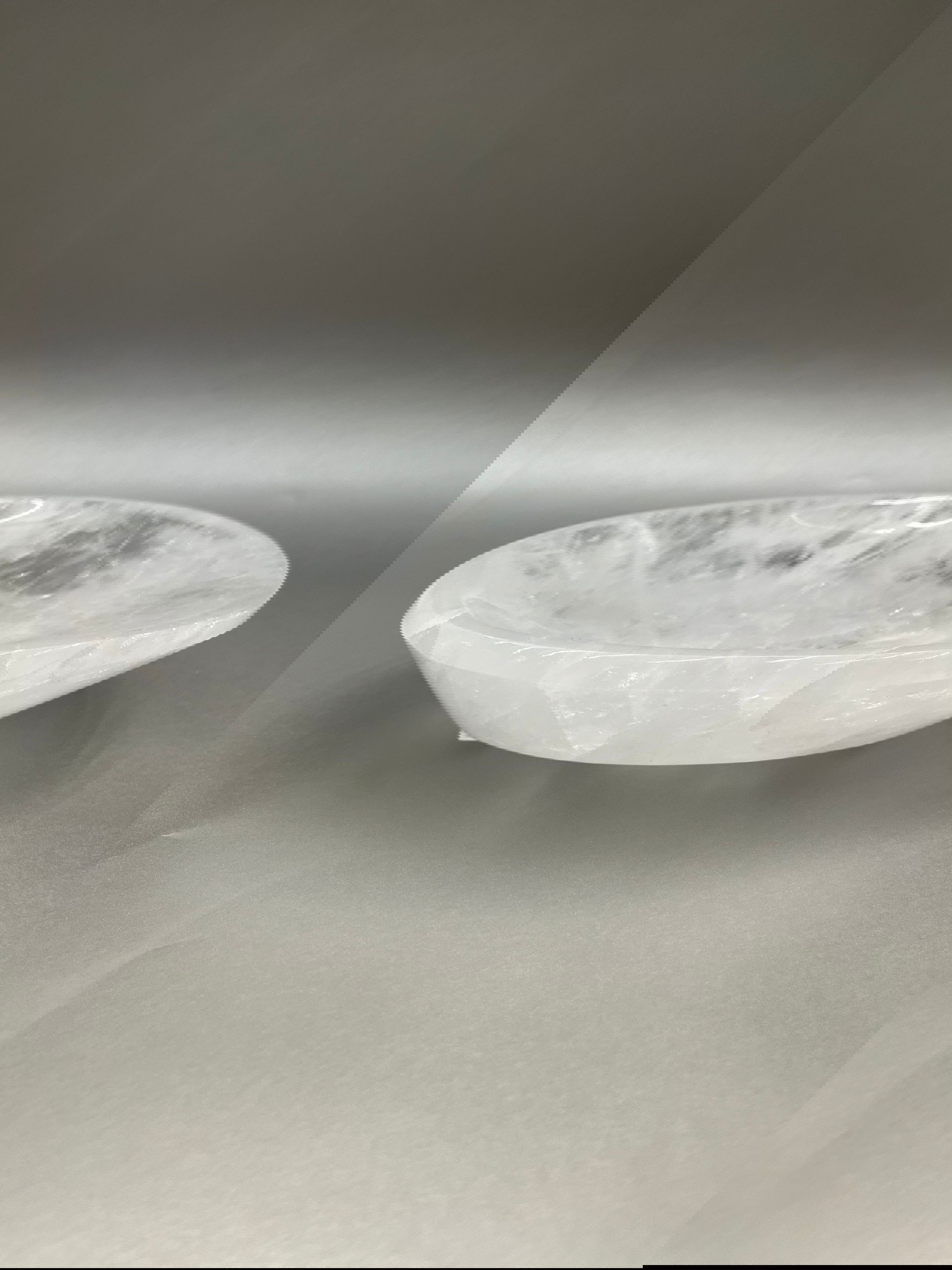 This Crystal Quartz Dish is meticulously polished to near perfection, making it a luxurious and exclusive find. Its shimmering surface radiates comforting vibes, making it an alluring addition for any living space. 9" x 7 Crystal Quartz Dish