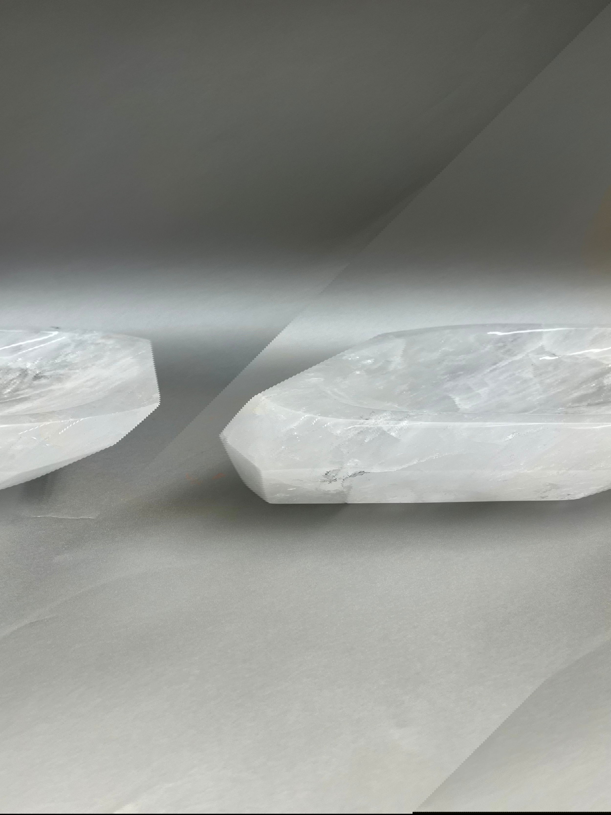This 2" thick Crystal Quartz Dish is meticulously polished to near perfection, making it a luxurious and exclusive find. Its shimmering surface radiates comforting vibes, making it an alluring addition for any living space. 10" x 7". Crystal Quartz Dish
