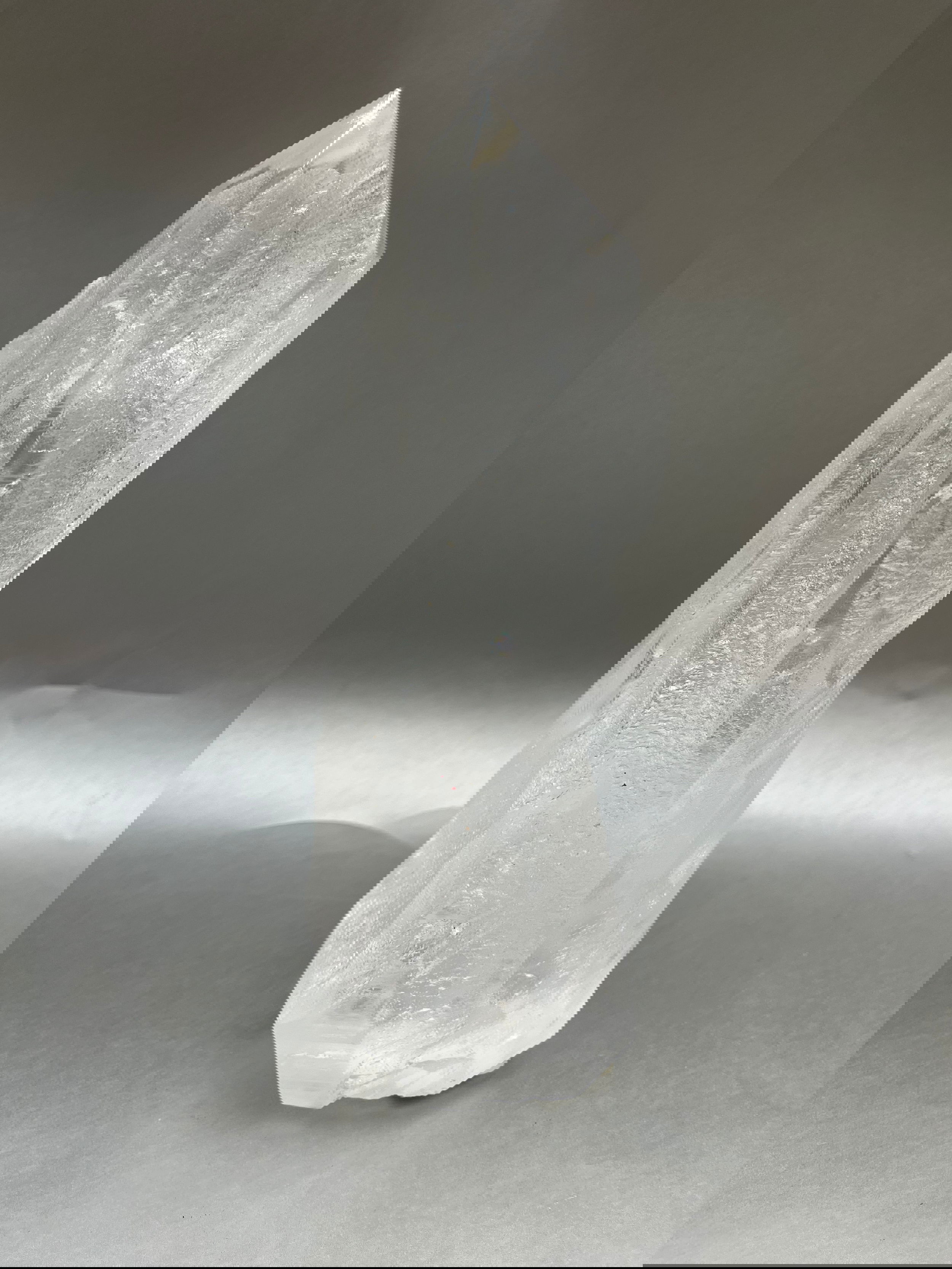 Luxuriate in the glittering beauty of Clear Ice Quartz Points, with their unique, twisted shapes crafted by nature's artistry. 10" x 3". Clear Ice Quartz Obelisk