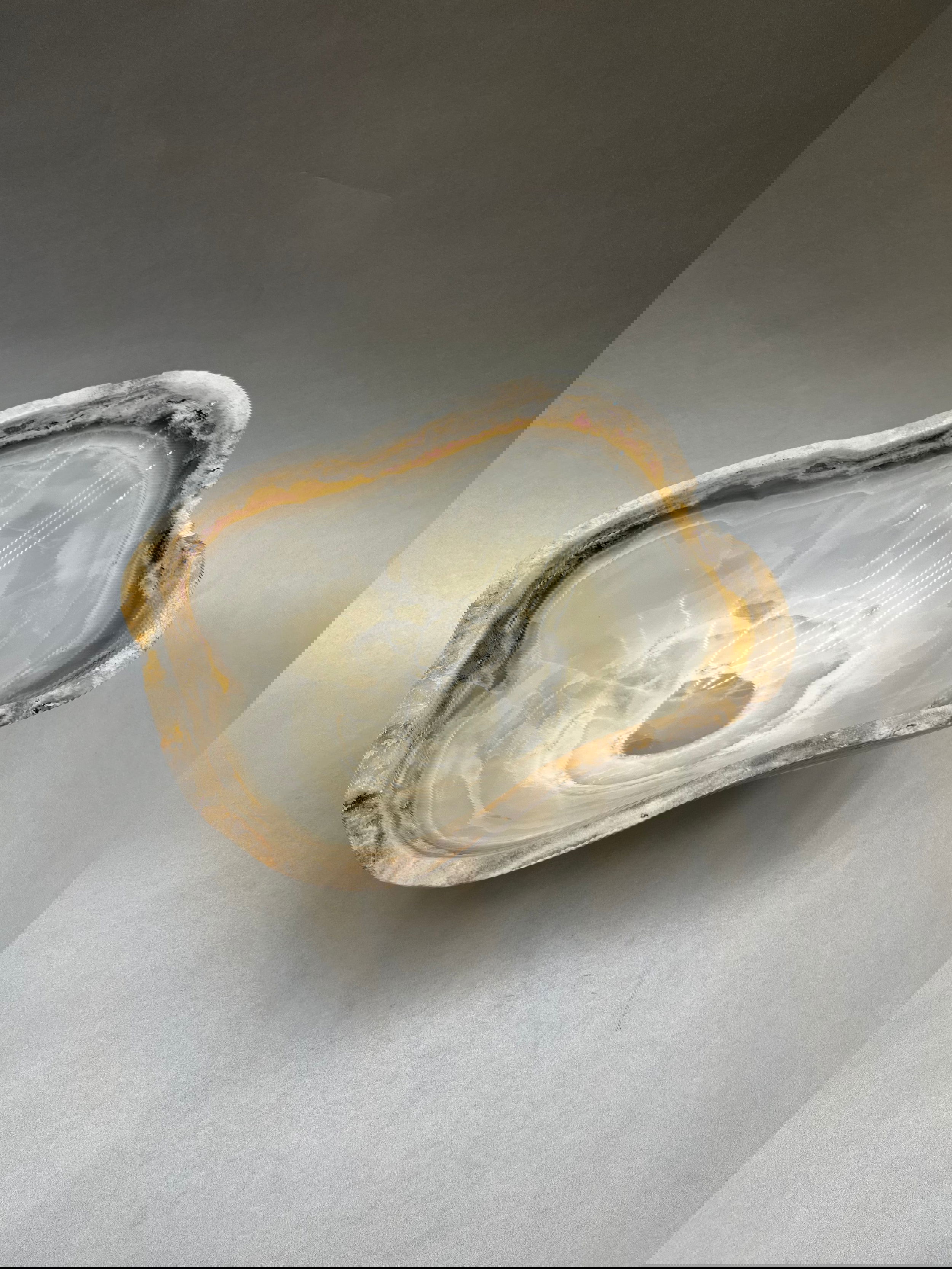 Delight in the timeless beauty of this 9" x 6.5" Light Onyx Polished Bowl, a luxurious creation designed with stunning handcrafted details. Light Onyx Polished Bowl