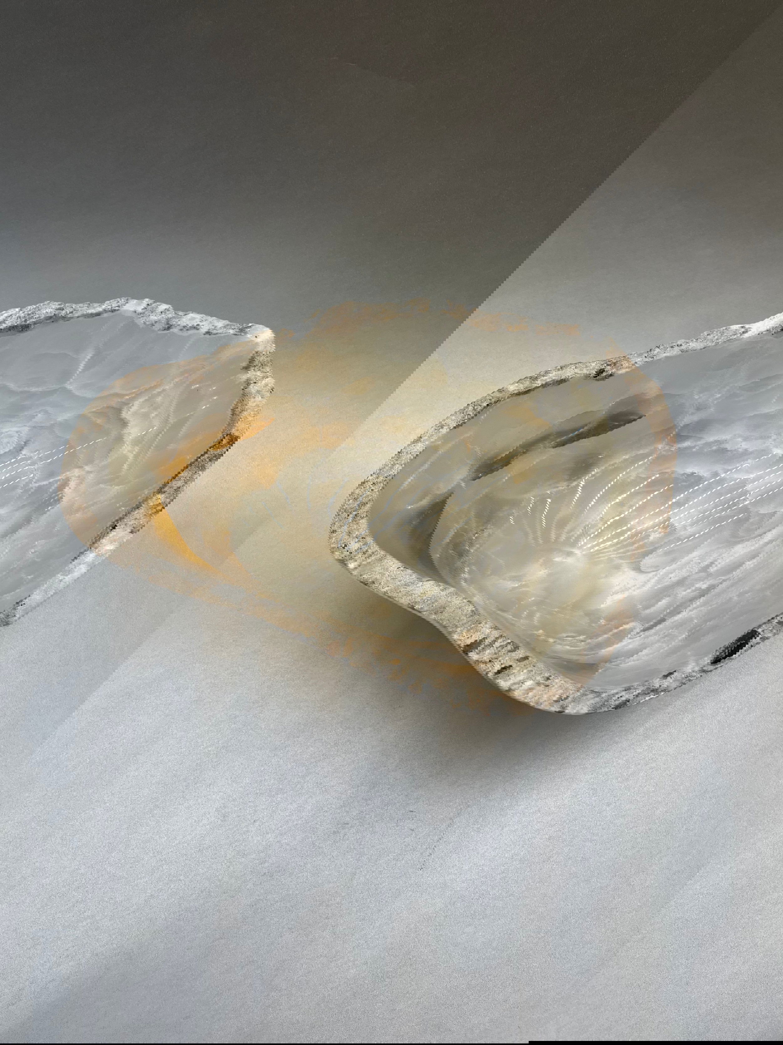 Delight in the timeless beauty of this 9" x 7" Light Onyx Polished Bowl, a luxurious creation designed with stunning handcrafted details. Light Onyx Polished Bowl