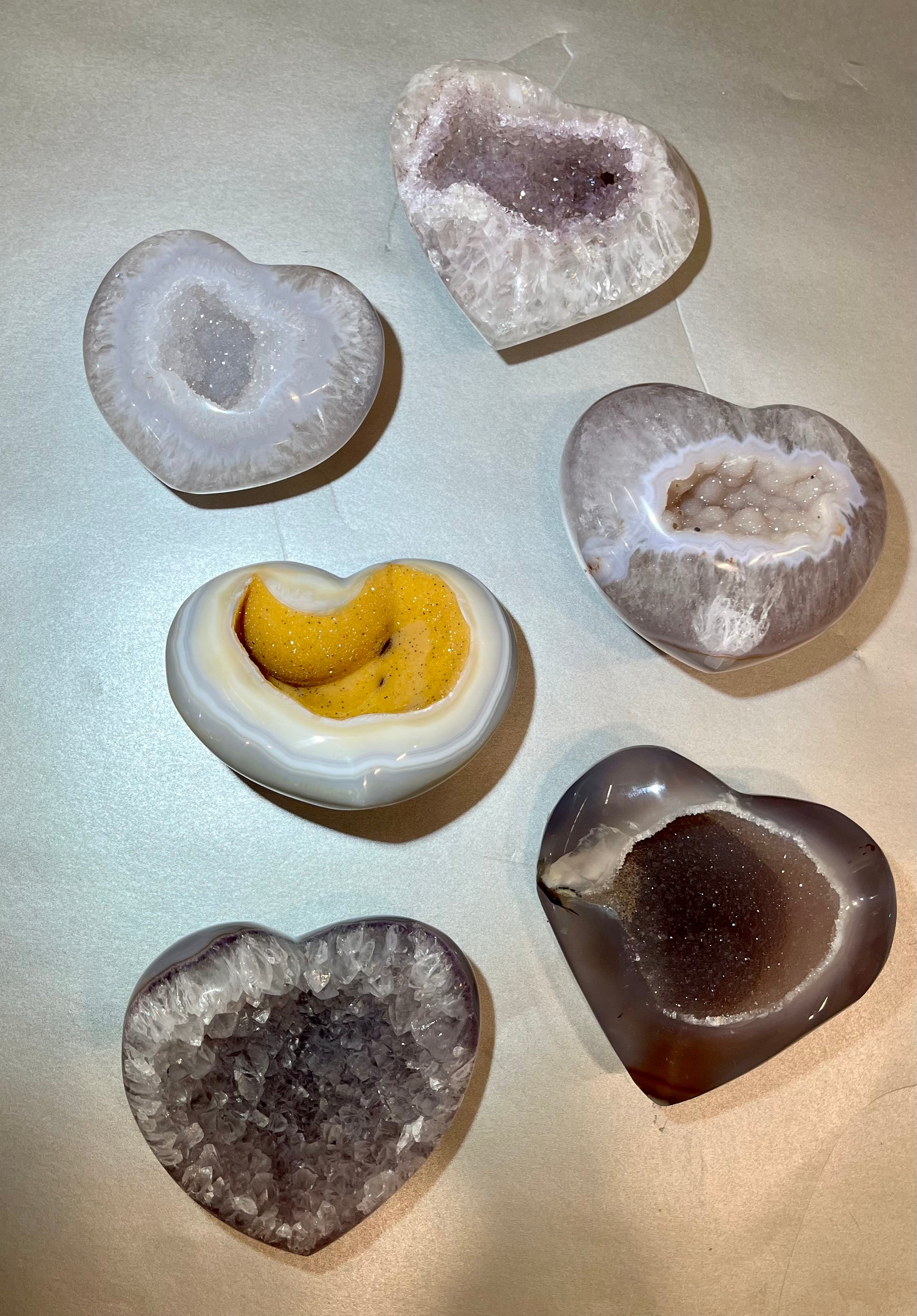 These mid-size Druze agate pieces are beautiful gemstones, each with the unique shape of a heart. The Druze variety usually has a distinct crystalline surface with tiny sparkling crystals embedded within. These are lovely little minerals that would make a wonderful gift or addition to your personal collection. Style and color will vary per stone in your order. Druse Heart- Medium