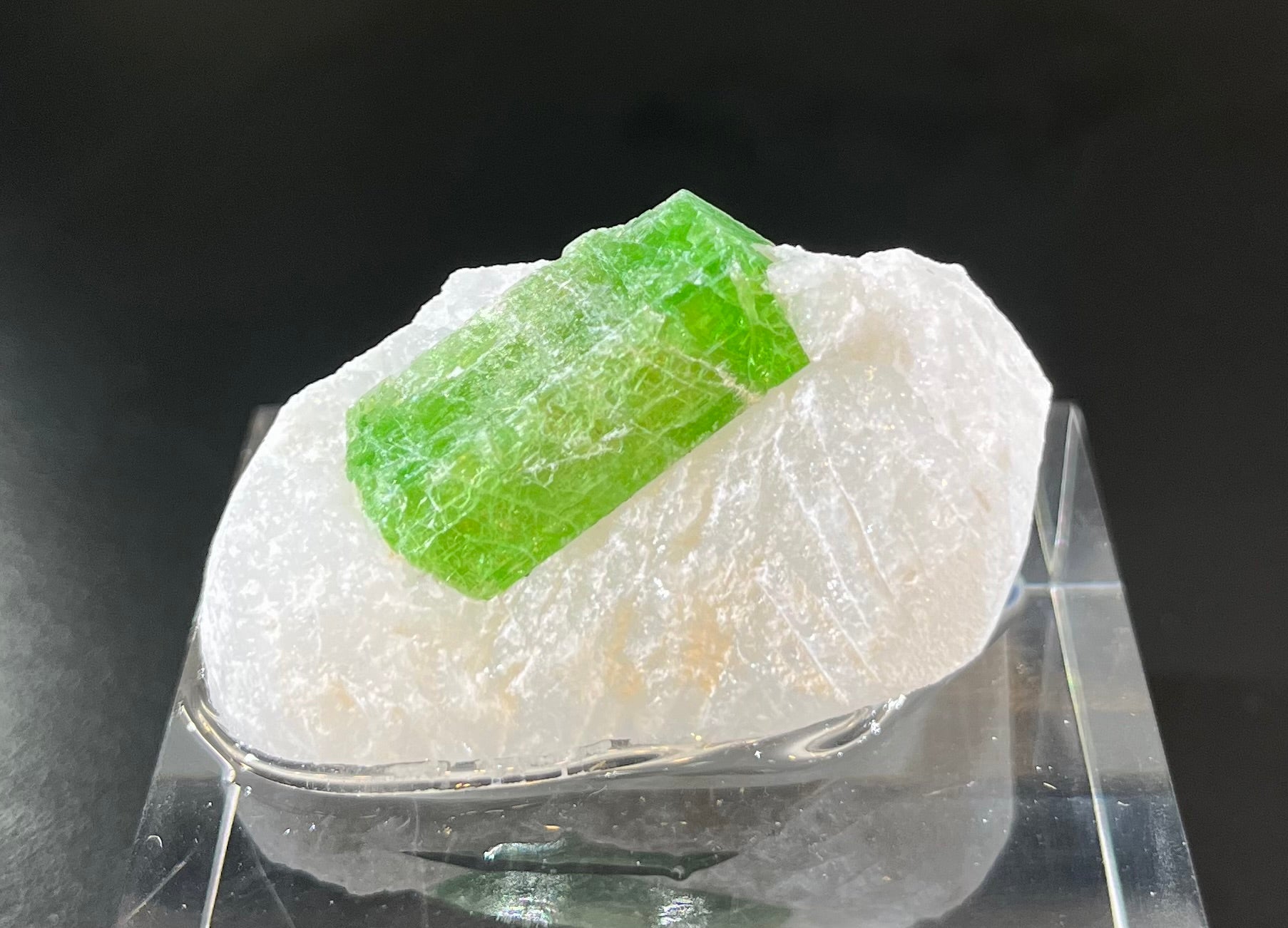 This unique pargasite specimen is encased in a white marble matrix, mined in the Long Troy Mined from An Phu, Vietnam. Behold this special mineral specimen with its beautiful colors and energetic properties, perfect for any collector or curio cabinet.Approx. 1" x 1 1/2" Pargasite Mineral Specimen