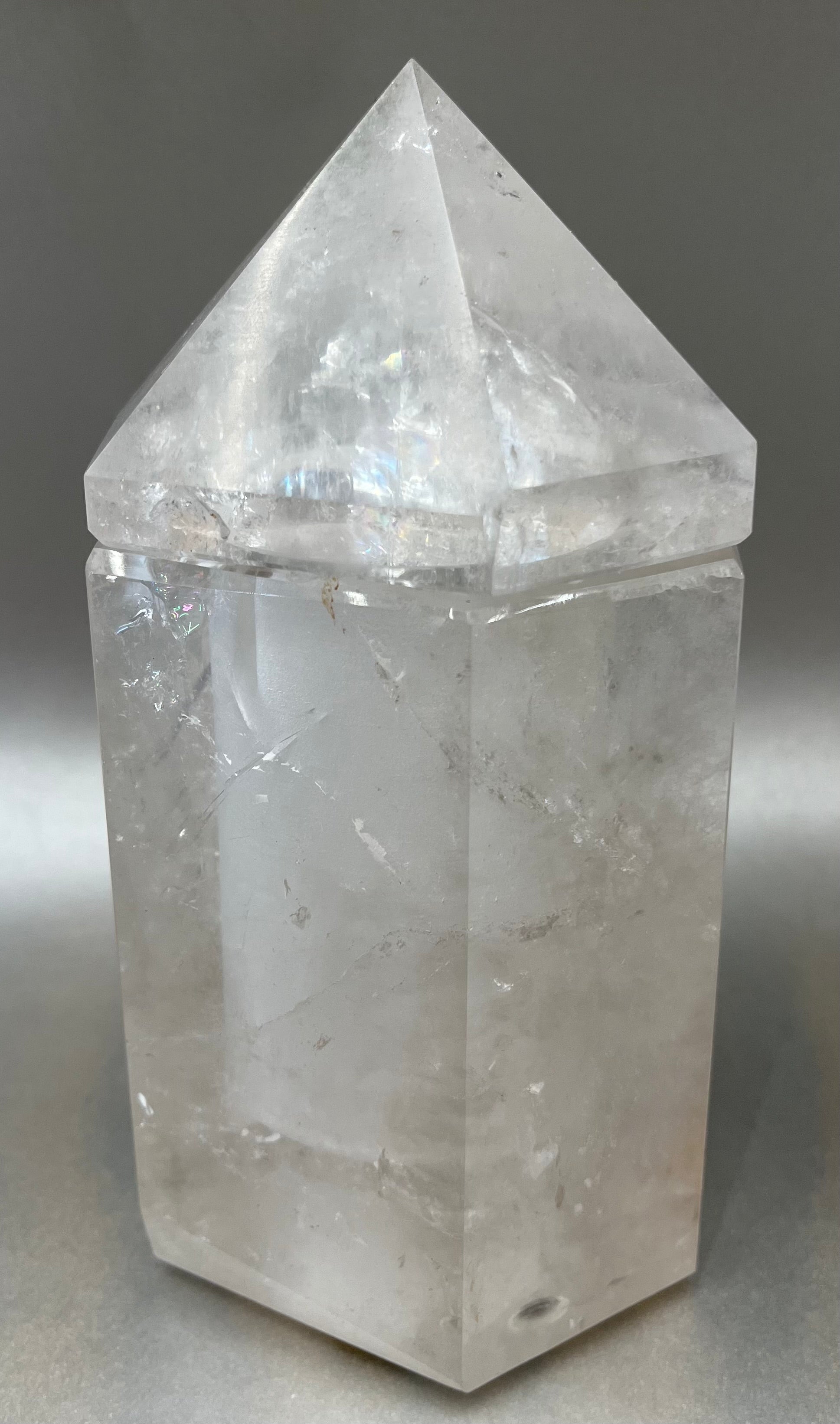 Indulge in the luxury of our Ice Quartz Obelisk Container. Crafted with a stunning quartz, this obelisk container doubles as a holder for your precious belongings or even more rock minerals! With its elegant silhouette, it adds a touch of sophistication to any space. Elevate your surroundings with this exclusive and timeless piece.Measures approx. 7" x 3.5". Quartz Obelisk Container
