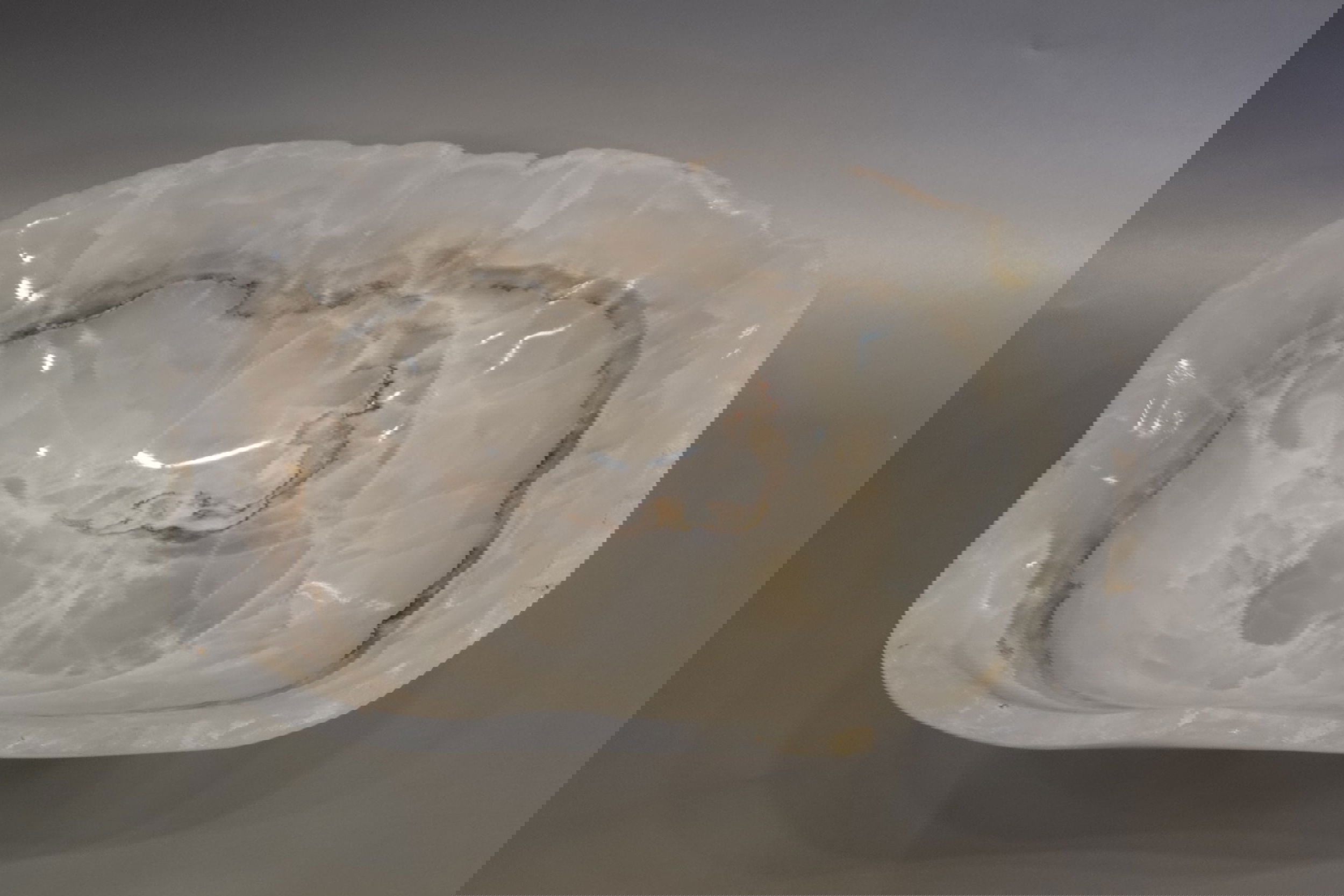 Indulge in the luxury of this exquisite Rustic Onyx Bowl. Handcrafted from the finest onyx, this bowl boasts a unique rustic banded design that exudes sophistication and charm. Perfect for adding a touch of elegance to any space, this bowl is a true statement piece that will elevate your decor.Approx. 14.25" x 4.5" Rustic Onyx Bowl