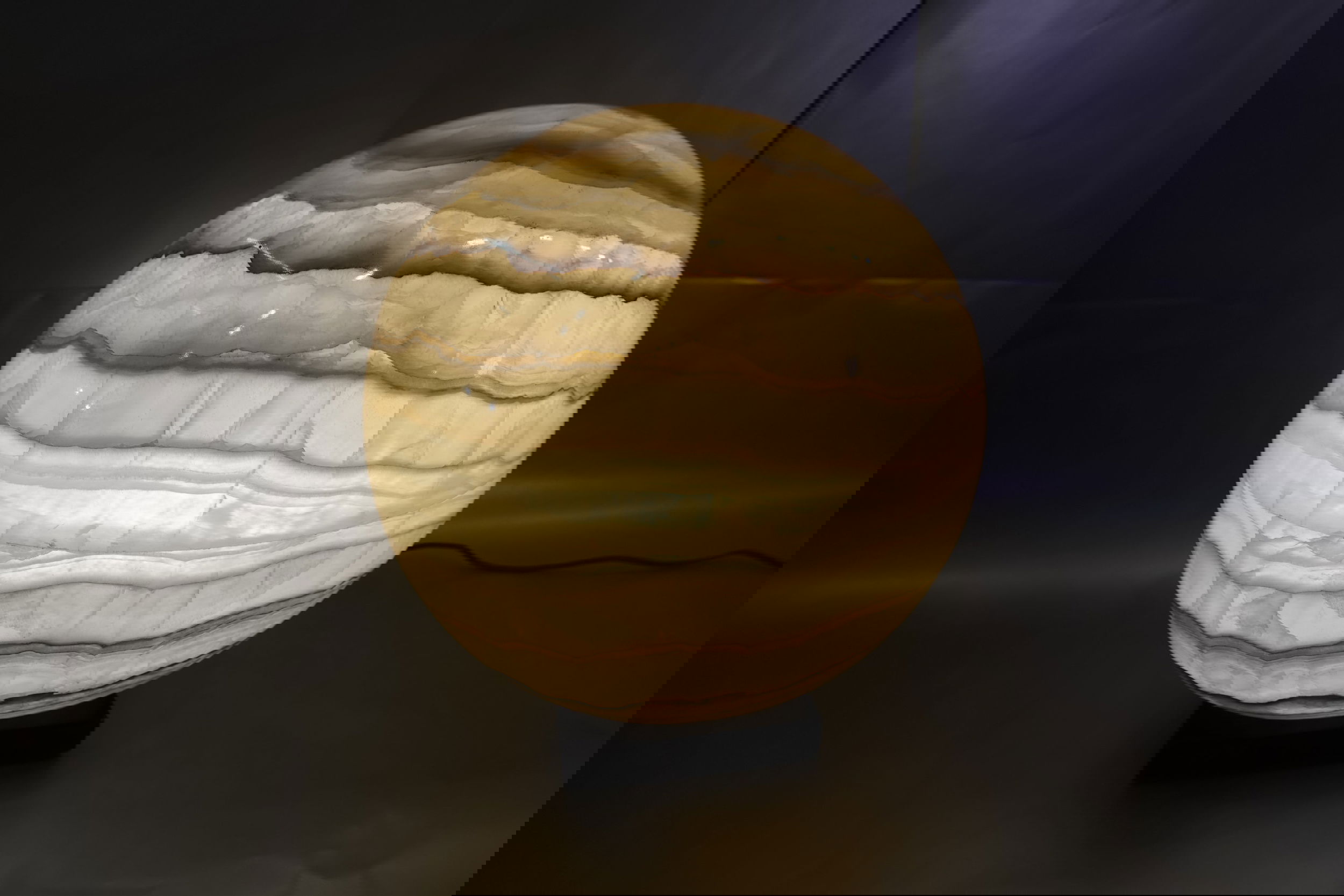 The 14" x 17" Onyx Globe , with feathery inclusions, beckons reflections of a mythical gaseous planet. Rustic Onyx Glow Sphere