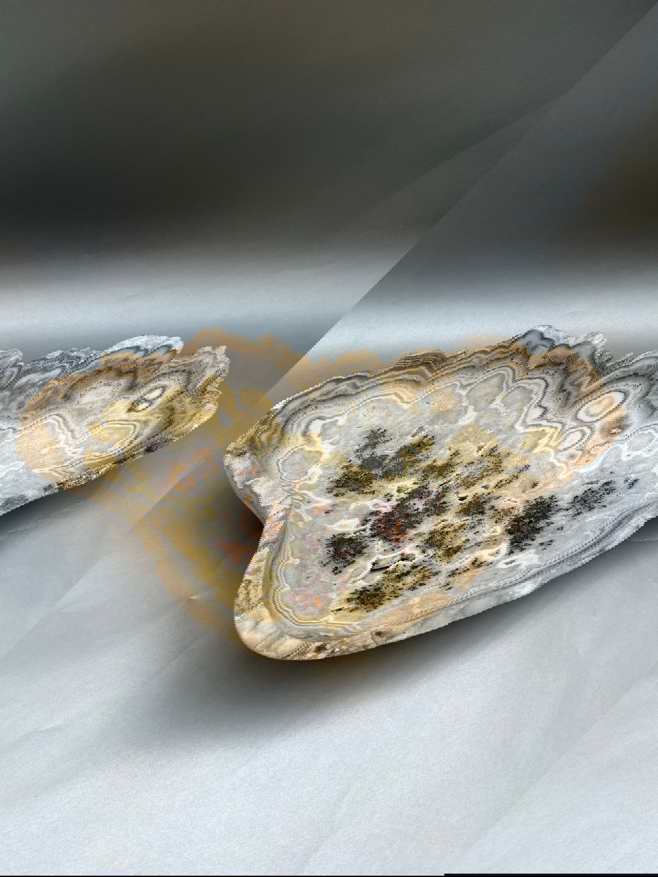 Introducing our exquisite Seafoam Stalagmite Bowl. Handcrafted from delicate seafoam glass, this unique piece makes a bold statement in any space. Elevate your decor with the beauty of nature, captured in a luxurious and exclusive design. Bowl measuring at 17" x 10". Seafoam Stalagmite Bowl