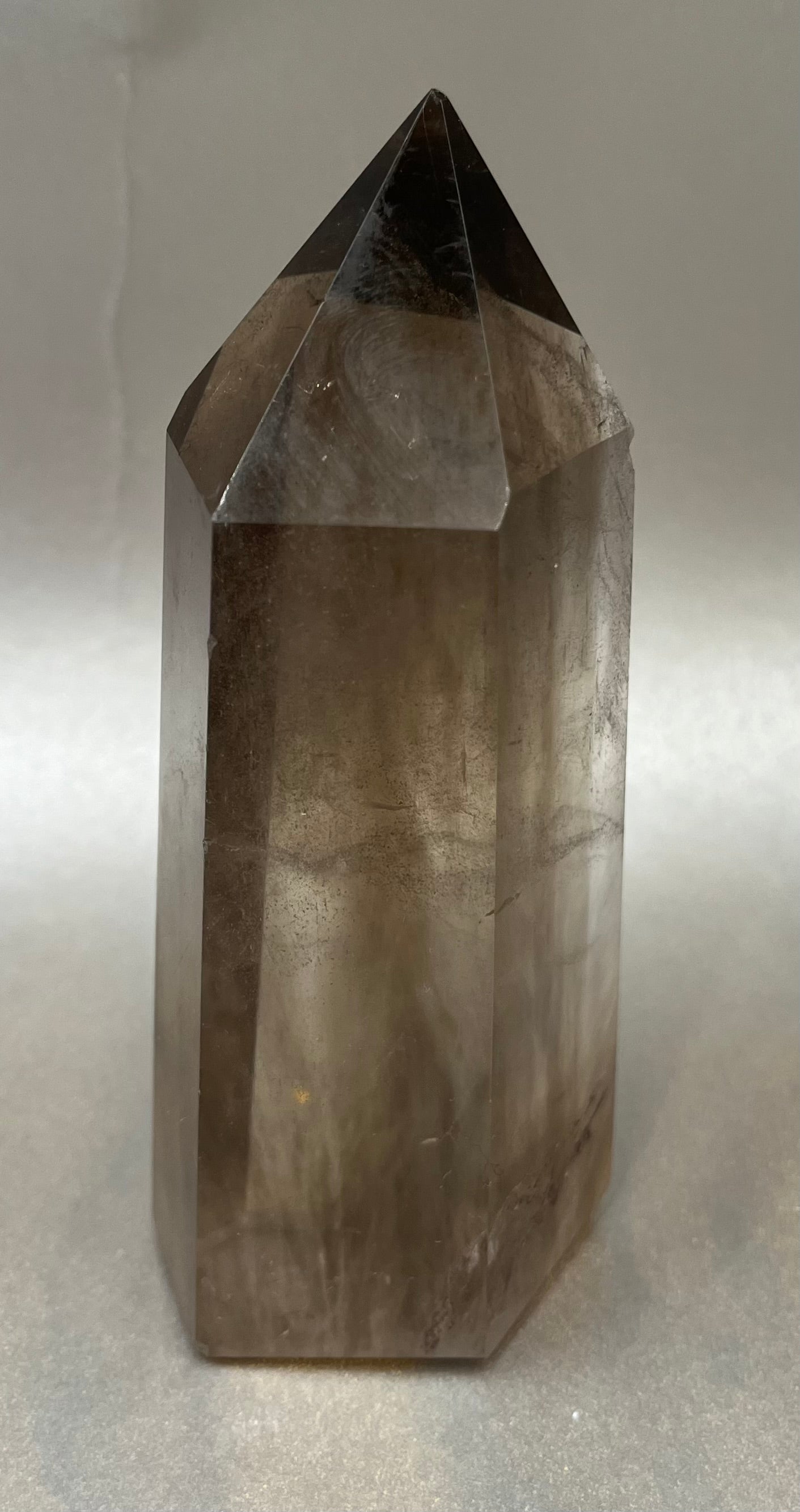 This captivating Dark Smokey Quartz Point offers an exquisite addition to any collection, with its opulent details and alluring mystery. Dark Smokey Quartz Obelisk