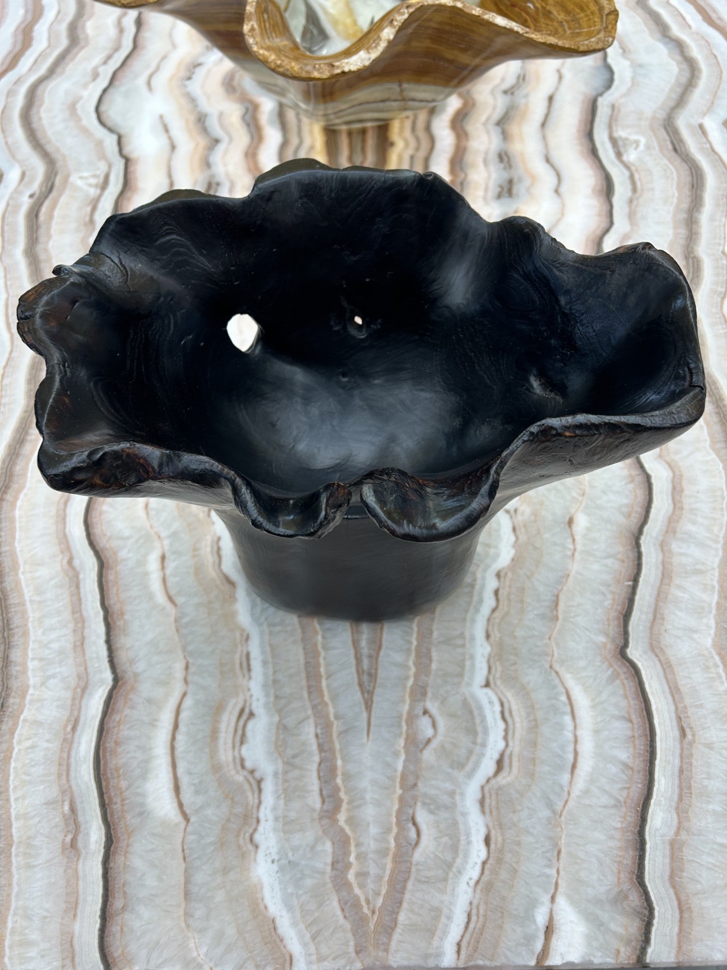 Crafted from luxurious teak wood, our Burnt Teak Bowl is a one-of-a-kind statement piece. The black color and freeform design add an elegant touch to any decor. Elevate your home with this exclusive, artisanal bowl.Approx. 12.5"L x 9.25"W x 9.25"H Burnt Teak Bowl