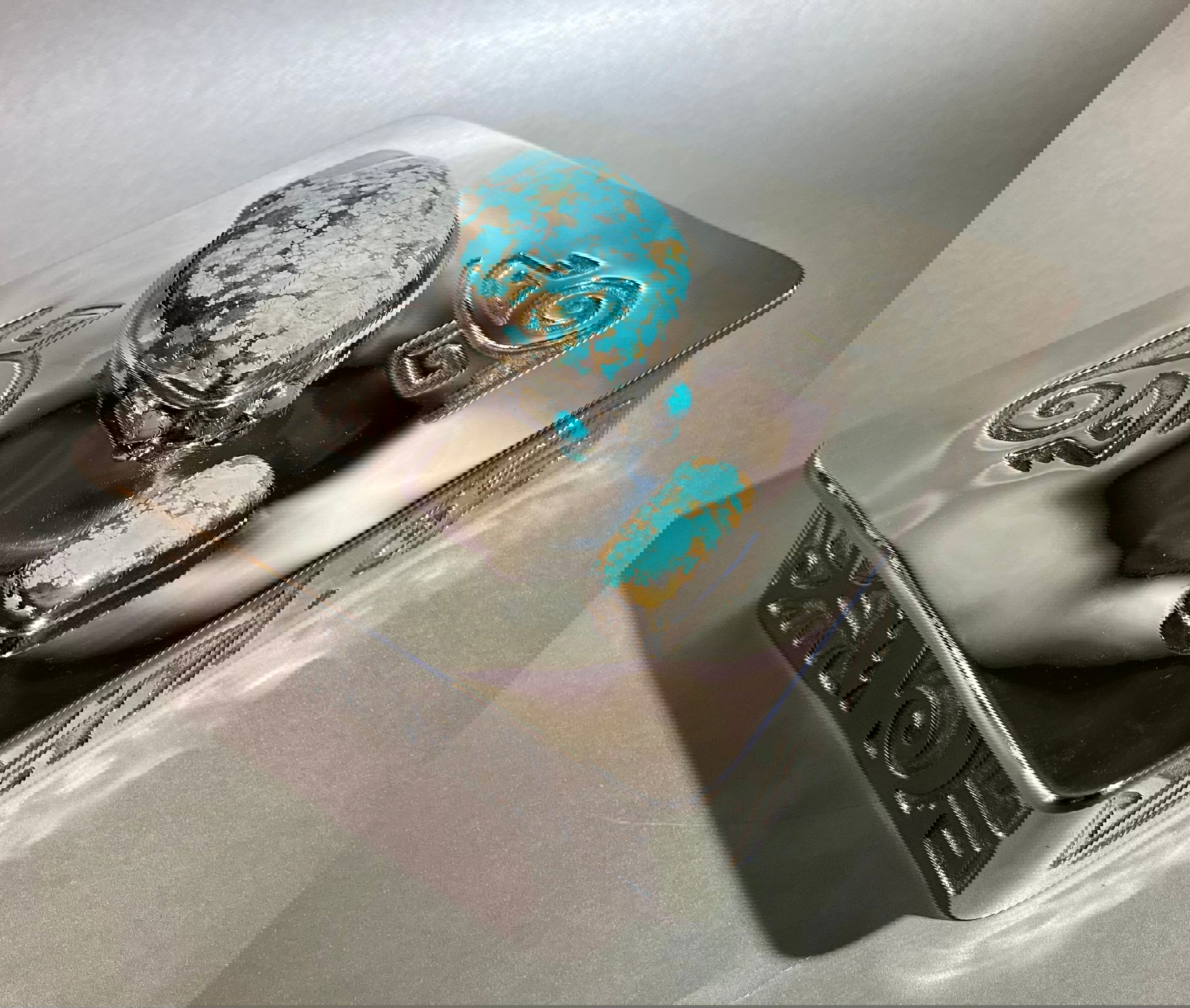 This opulent Nickel Silver Treasure Box flaunts a brilliant turquoise accent, exquisitely hand-forged silver soldering, and a lavishly acid-etched design with supple leather lining. Approx 6 1/4 x 6 1/4 x 2" deep. Nickel Silver Treasure Box w/ Turquoise
