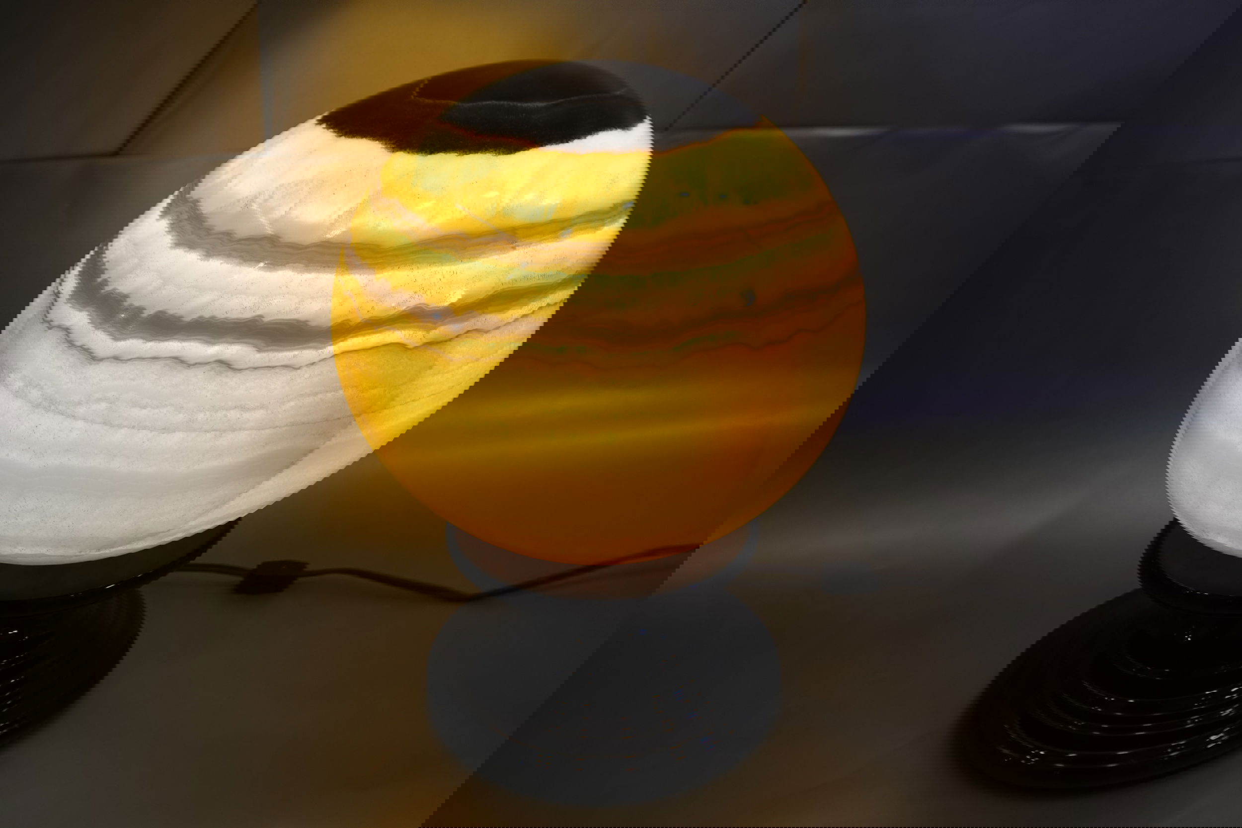The 10" x 15.5" Onyx Globe , with feathery inclusions, beckons reflections of a mythical gaseous planet. Zebra Onyx Glow Sphere