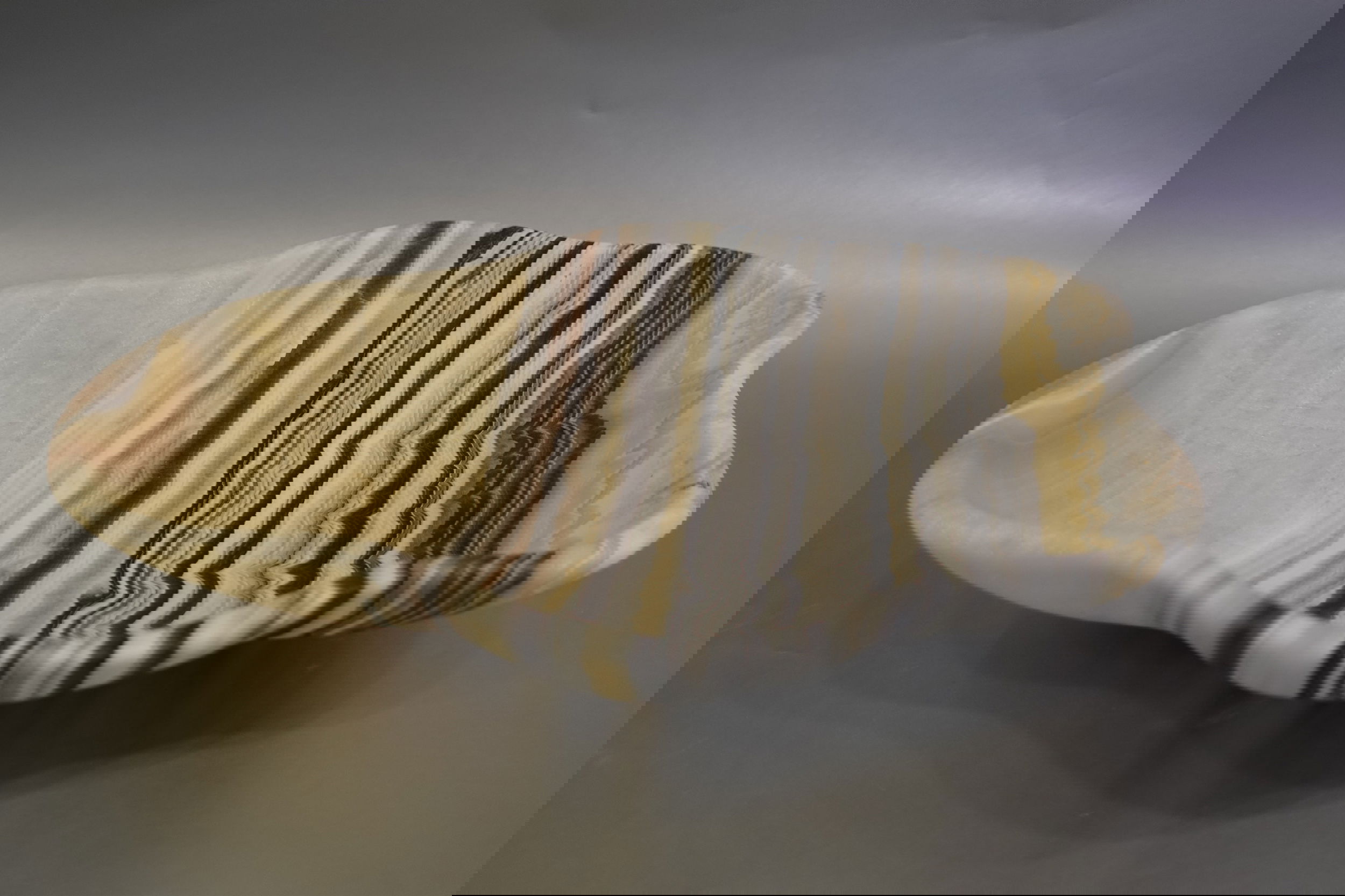 Indulge in the luxurious uniqueness of our Zebra Onyx Bowl. Its banded surface showcases the exquisite patterns of zebra onyx, while its distinct shape adds a touch of sophistication. Elevate your home decor with this exclusive piece that exudes elegance and refinement.Approx. 13" 2.75" Zebra Onyx Bowl