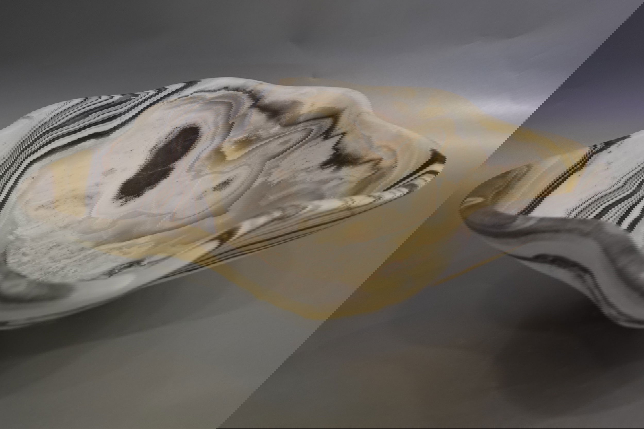 Indulge in the luxurious uniqueness of our Zebra Onyx Bowl. Its banded surface showcases the exquisite patterns of zebra onyx, while its distinct shape adds a touch of sophistication. Elevate your home decor with this exclusive piece that exudes elegance and refinement.Approx. 14.5" x 5" Zebra Onyx Bowl
