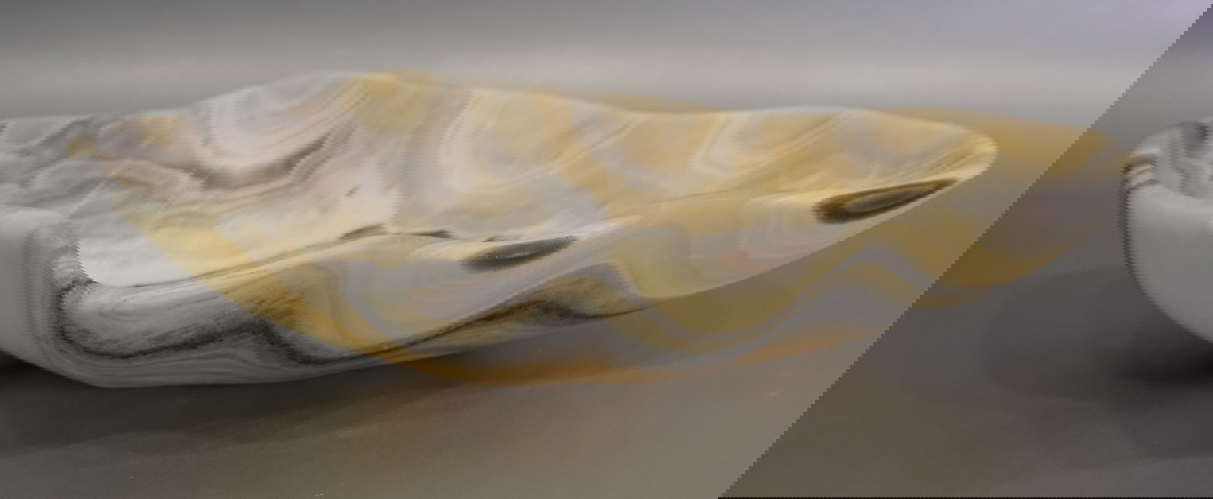 Indulge in the luxurious uniqueness of our Zebra Onyx Bowl. Its banded surface showcases the exquisite patterns of zebra onyx, while its distinct shape adds a touch of sophistication. Elevate your home decor with this exclusive piece that exudes elegance and refinement.Approx. 13.5" 3" Zebra Onyx Bowl