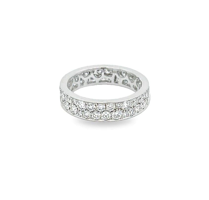 The "Eternal Star" eternity band in 18k white gold is a breathtaking display of continuous brilliance, featuring two rows of sparkling diamonds that encircle the entire band. Each diamond is carefully set to maximize its shine, creating a radiant and timeless look. (Discontinued Item; Last Piece In Stock)-18k White gold-Round diamonds, 2.05cts-Size 6.5, Contact For Sizing OptionsItem# 120-00110 Eternal Star Eternity Band
