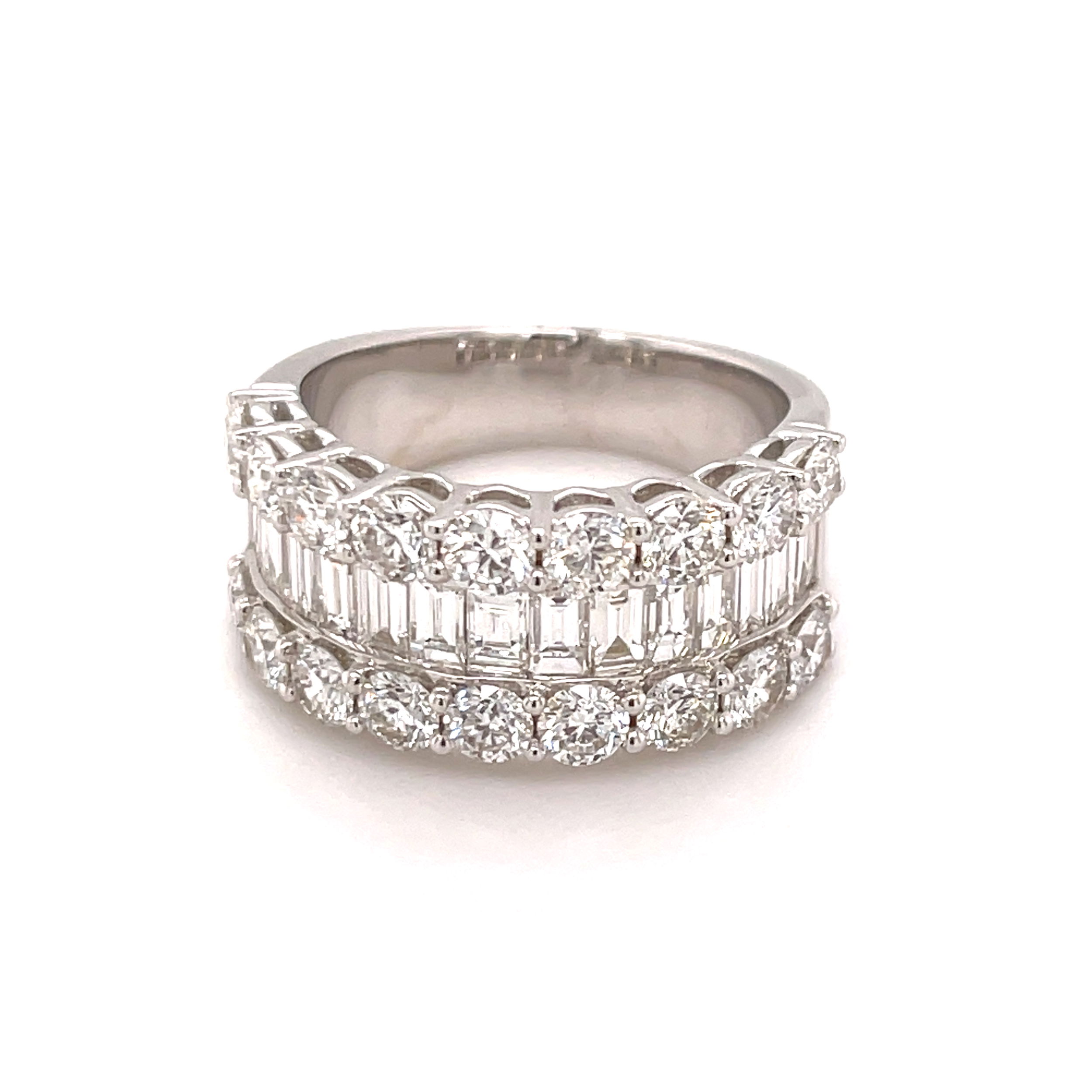 This elegant 18k White gold anniversary band features baguette diamonds beautifully set between two sparkling rows of round diamonds. The classic combination of shapes adds dimension and brilliance, creating a sophisticated yet timeless look. A perfect way to celebrate your love and commitment.-18k White gold-Baguette Diamonds, 1.01cts-Round Diamonds, 1.93ctsSize 6.5, Contact for sizing optionsItem# 130-01026 Diamond Anniversary Band