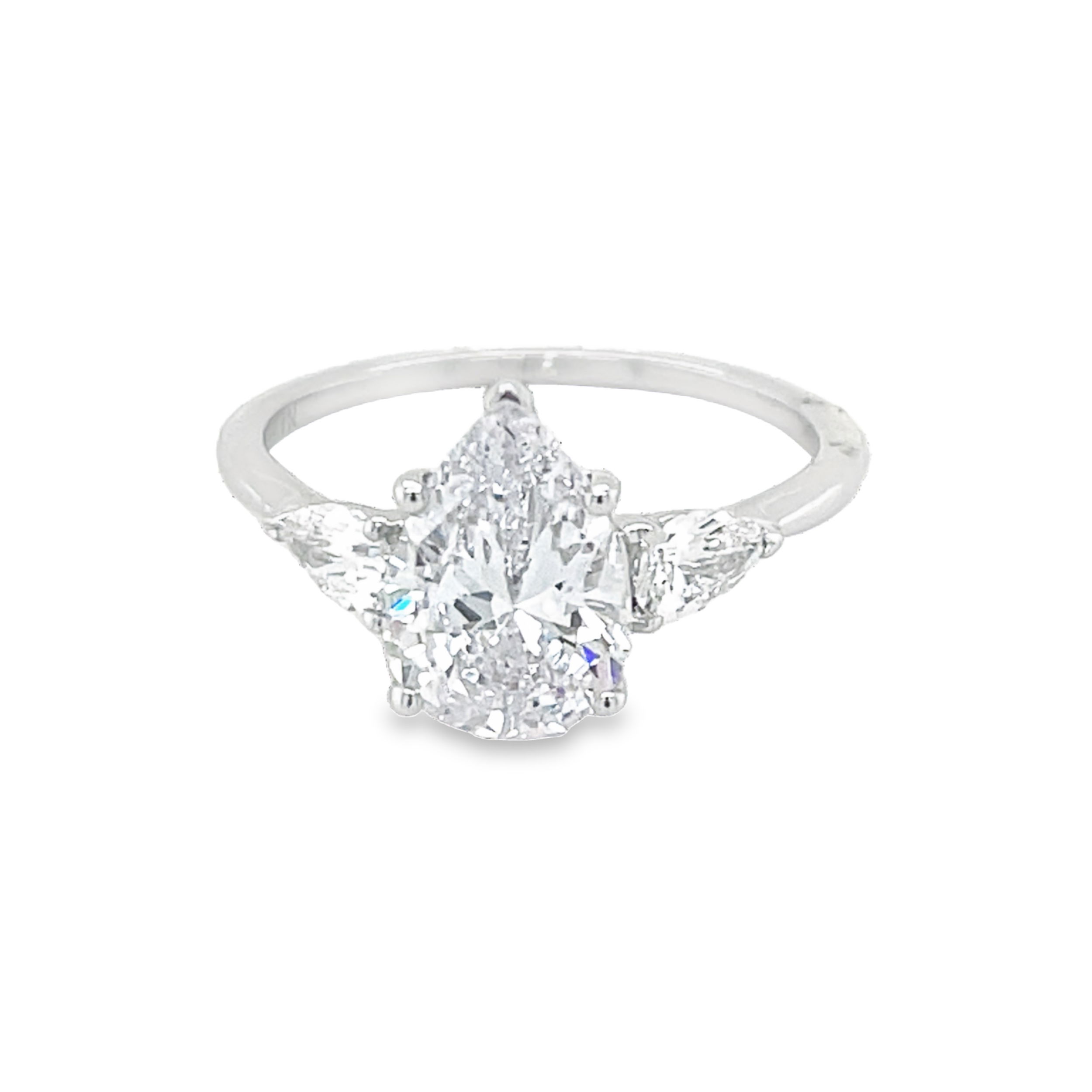 Designed for elegance and brilliance, this three-stone semi-mount in 18k white gold features two pear-shaped side diamonds that beautifully complement the center, enhancing its sparkle and creating a balanced, sophisticated look. A timeless setting that symbolizes your past, present, and future—perfect for a meaningful and breathtaking engagement ring. (Center stone not included)-18k White gold-Pear Diamonds, 0.50cts-Size 6.5, Contact for sizing ptionsItem# 140-00200 Seraphina