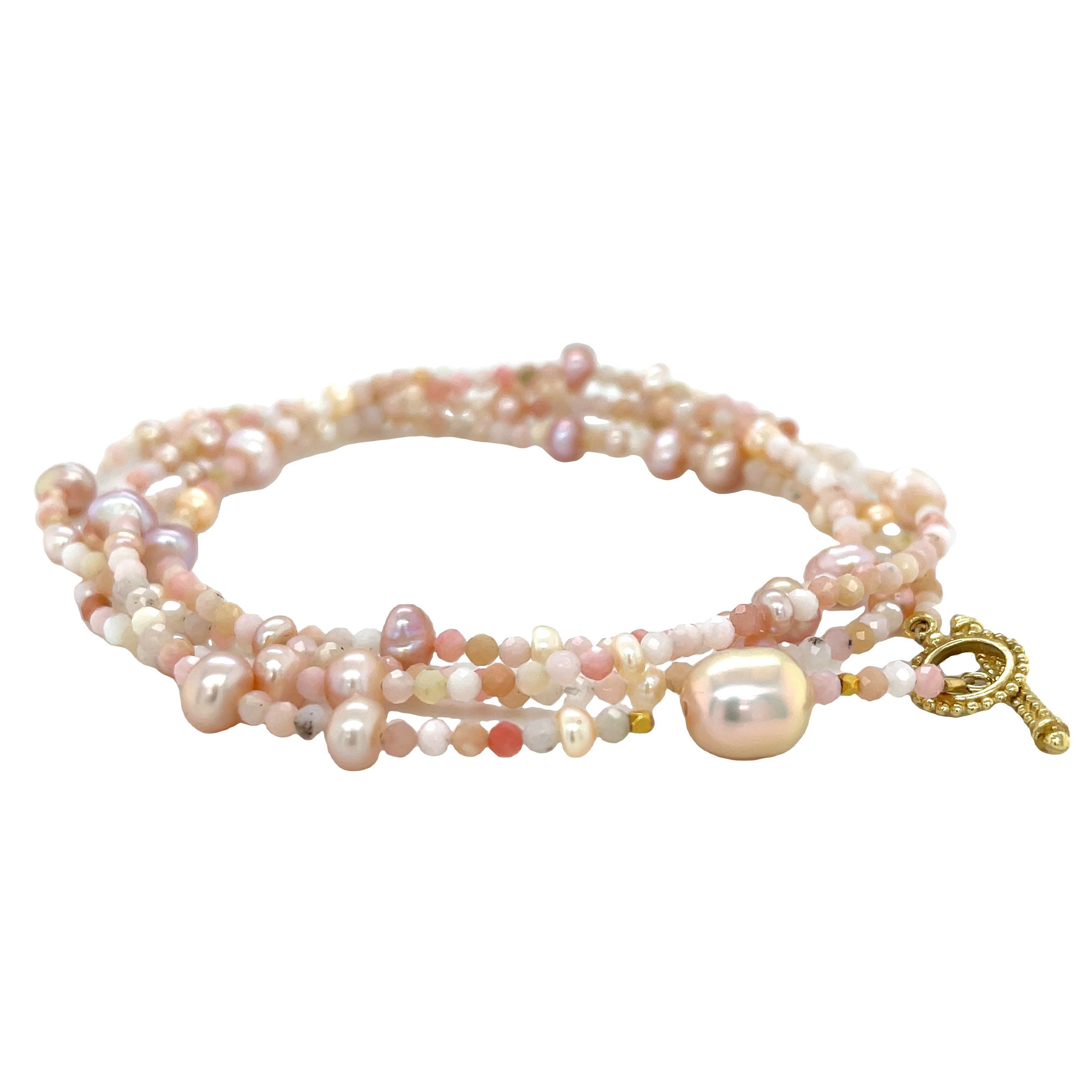 This stunning wrap bracelet combines the warmth of 18k yellow gold with the soft hues of pink pearls and opals. Wear it as a long necklace or layered for a unique and stylish touch. Pair with a Keepsake Finial Pendant for added styling options.-18k Yellow gold-Pink pearl and pink opal-Length 32”Item# 808-00797 Pink Opal and Pearl Convertible Wrap Bracelet 32”