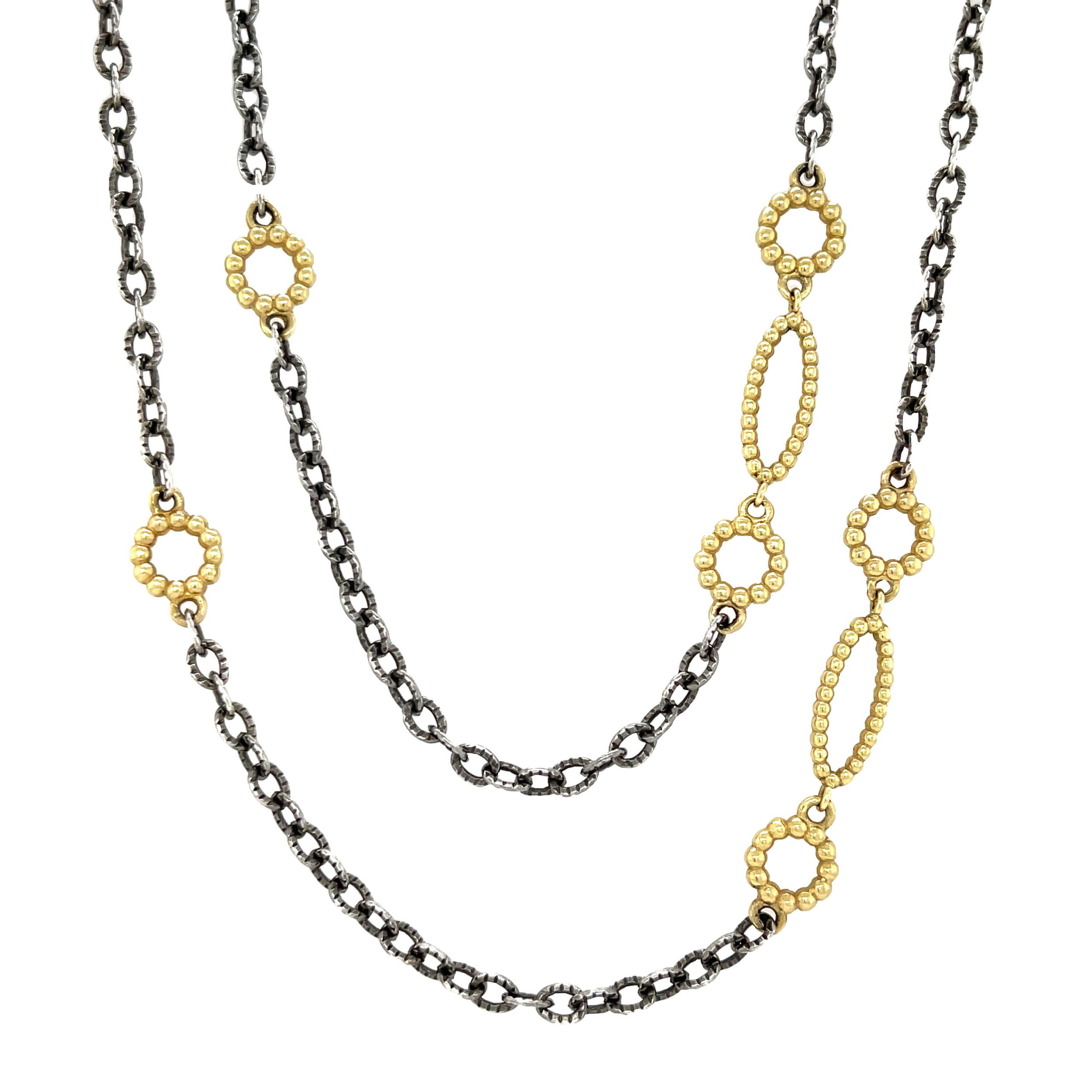 This necklace features oval links in oxidized sterling silver with touches of 18k yellow gold. Its bold yet simple design makes it easy to wear alone or layer with other pieces.-18k Yellow gold-Oxidized sterling silver-Oval linksLength 32”Item# 807-00670 Oval Link Necklace