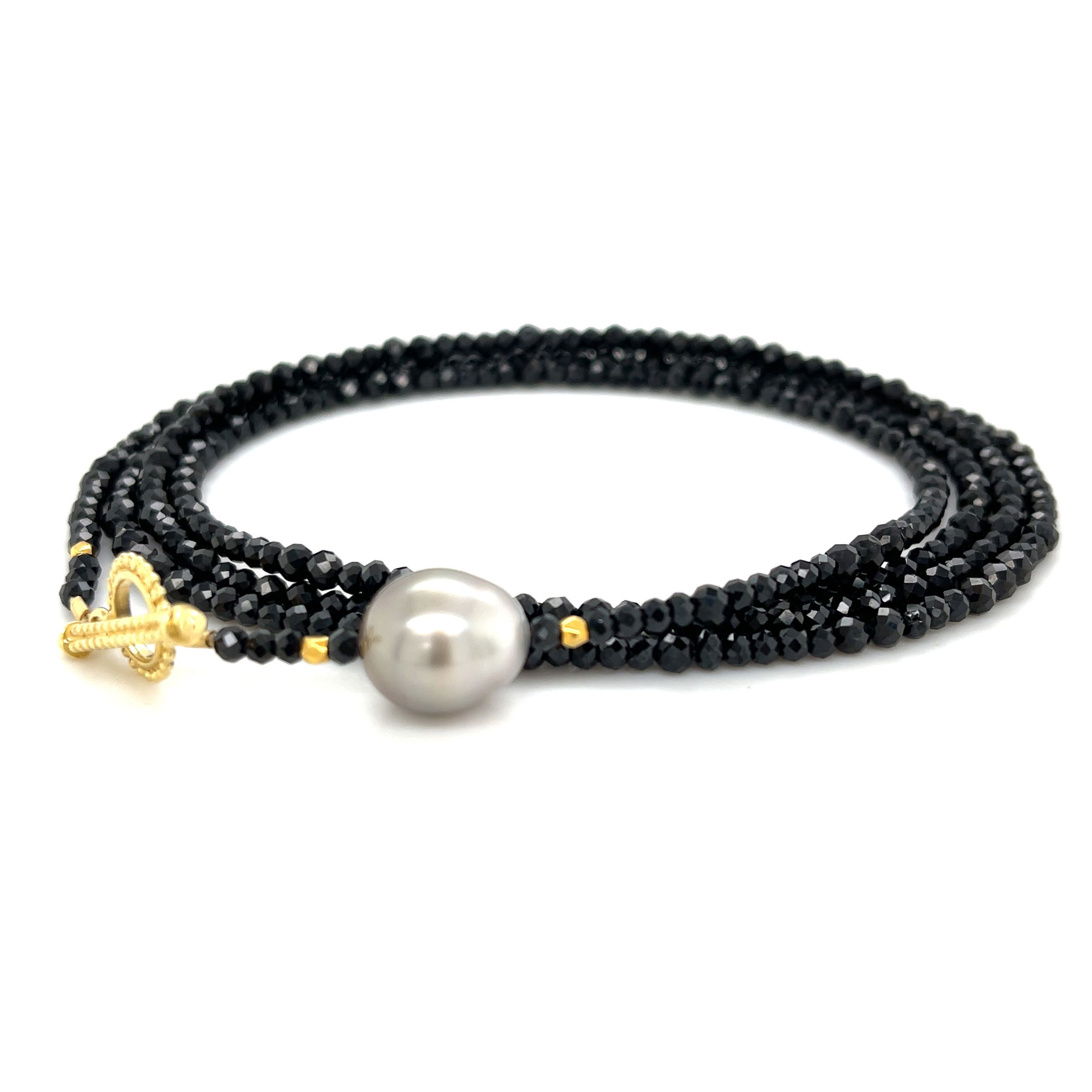 This black wrap bracelet with 18k yellow gold and a stunning Tahitian pearl brings a stylish, sophisticated touch to any outfit. It’s versatile too—wear it as a long necklace or layered for a different look. Pair it with an Empress Pendant to elevate your style and create even more unique combinations.-18k Yellow gold-Trilliant tahitian pearl-Length 33.5”. Contact for sizing options.Item# 808-00985 Tahitian Pearl Convertible Wrap Bracelet 33.5"