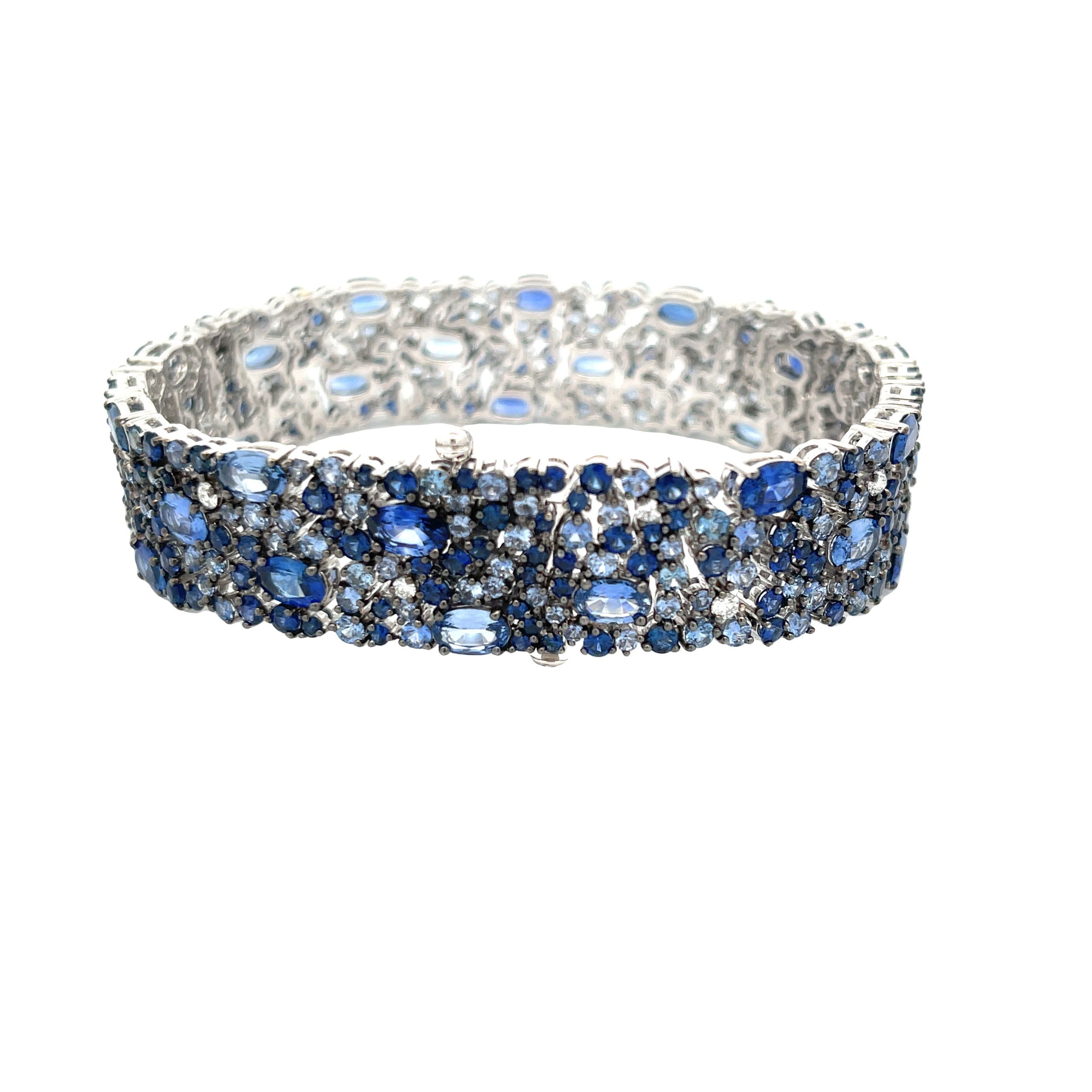 This 18k white gold bracelet features a stunning arrangement of sapphires and sparkling diamonds. Sophisticated and elegant, it adds a refined touch of color and brilliance to any ensemble.-18k White gold-Round and oval sapphires, 26.08cts-Round diamonds, D-F/VS+ 0.49cts-Size 7Item# 001-240-00329 American Glamour Bracelet