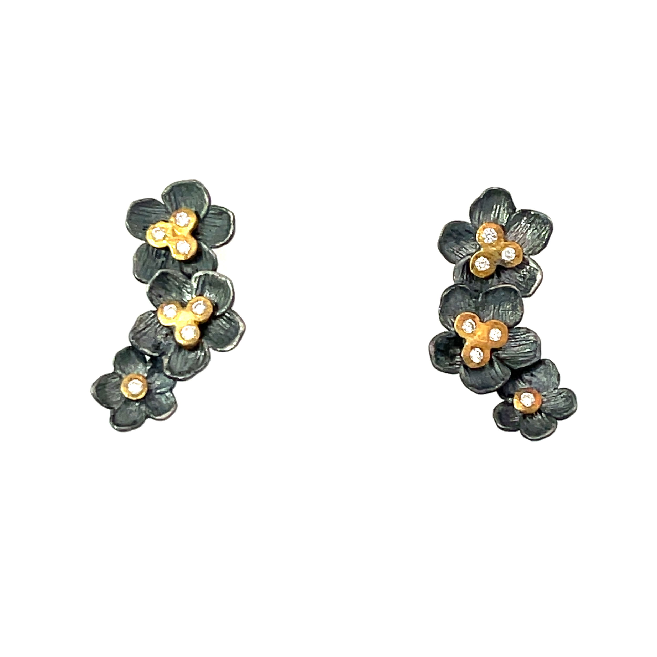 Presenting our Buttercup Climber Earrings—a fusion of oxidized silver and 22k yellow gold. These earrings feature a unique floral design, and are adorned with sparkling diamonds.-22k Yellow gold-Oxidized silver-Round diamonds 0.21ctsItem# 001-805-01537 Oxidized Silver and Gold Climber Earrings
