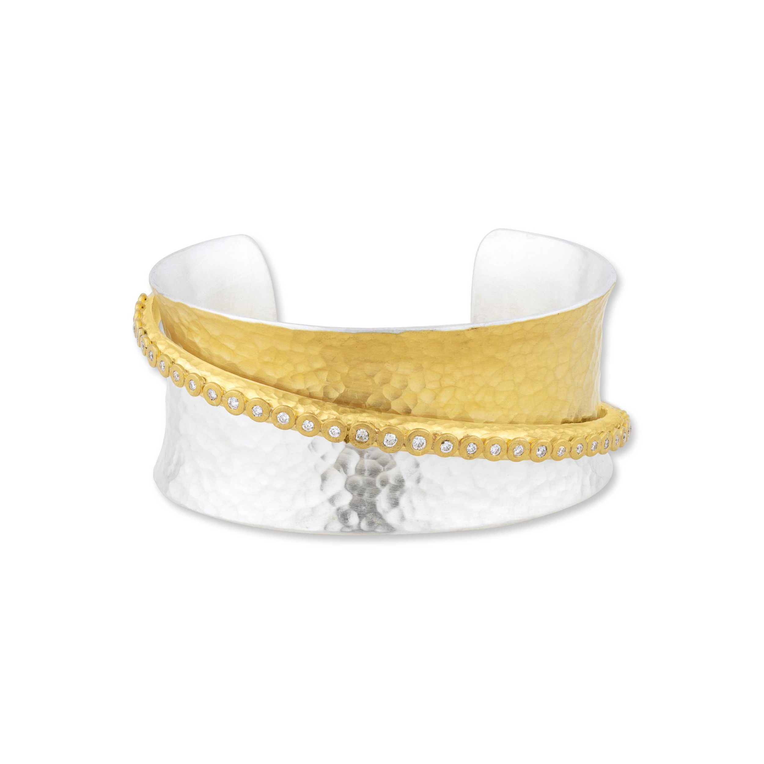 Elevate your elegance with this exquisite ladies' sterling silver and 24k yellow gold open cuff bracelet. Featuring a gracefully curved band with shimmering pavé diamonds, this timeless piece seamlessly blends luxury and sophistication.-24k Yellow Gold -Sterling Silver-Round diamonds, 0.65ctsItem# 001-808-00862 Gold and Silver Cuff with Diamonds