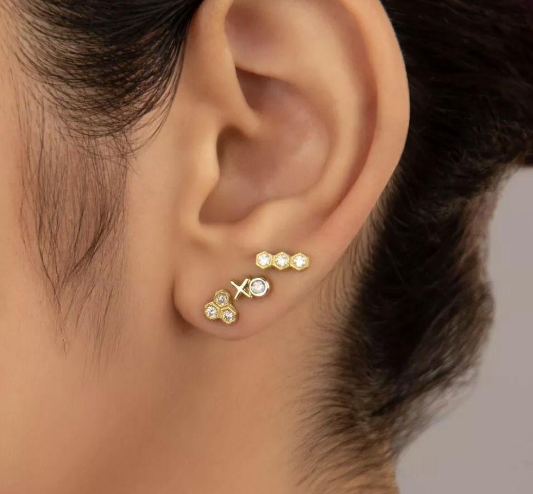 Combining classic elegance with on trend shapes and styles, JFJ offers something for women of all ages. From the Petites Collection, this stud features three pave white diamonds in a hexagon shape, aligned in a row in 18k yellow gold. Studs sold as singles.-18k Yellow gold-Round diamonds, 0.09ctsItem# 805-01109 Petite Three Hexagon Diamond Stud Earring