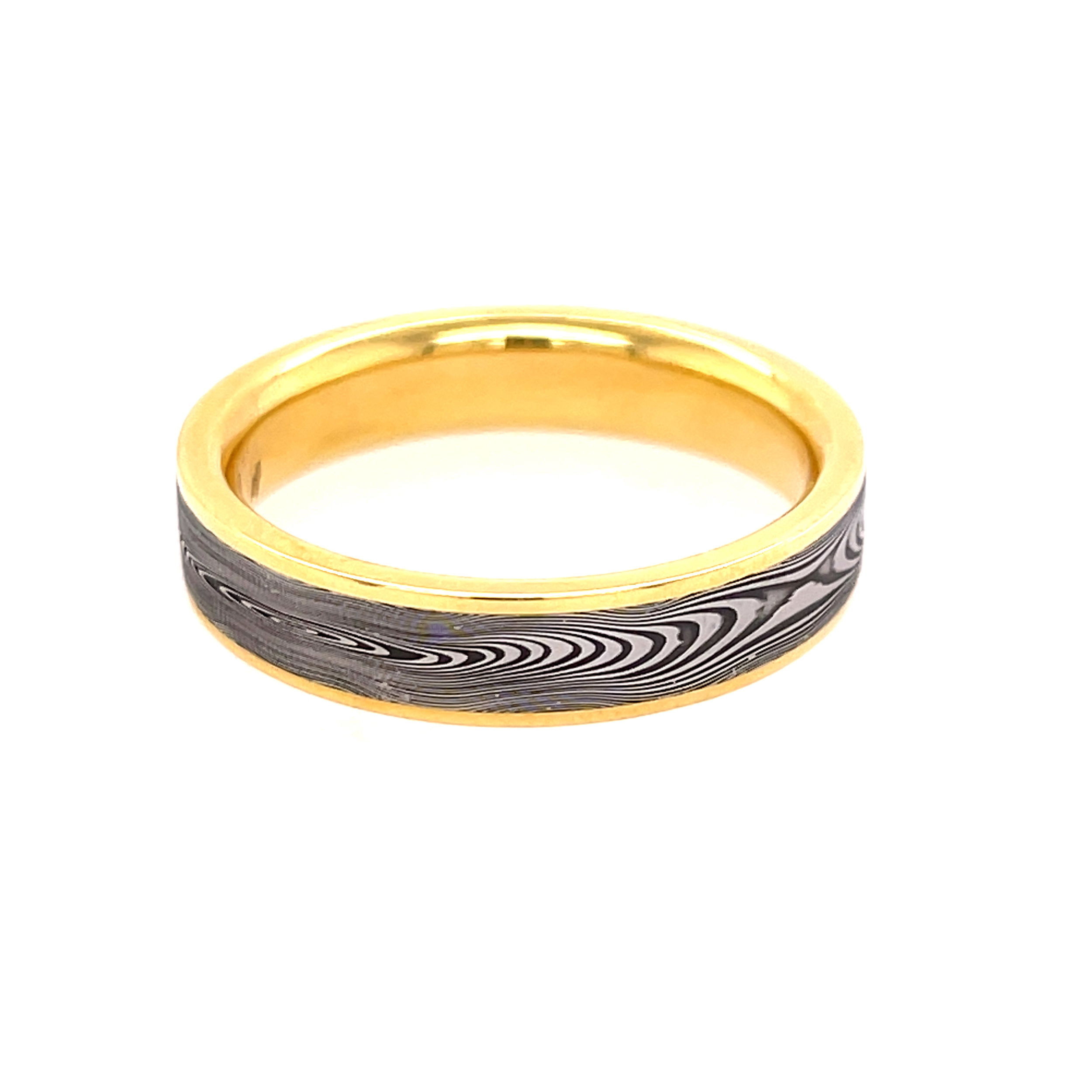 This flat profile men’s band showcases a bold Damascus steel center, known for its flowing, woodgrain-like pattern. Framed by sleek 18k yellow gold edges, the contrast creates a refined yet rugged look—perfect for someone who values strength, style, and individuality.-18k Yellow gold and Damascus -5mm-Size 10.5, Contact for sizing optionsItem# 405-00064 Damascus Men's Band