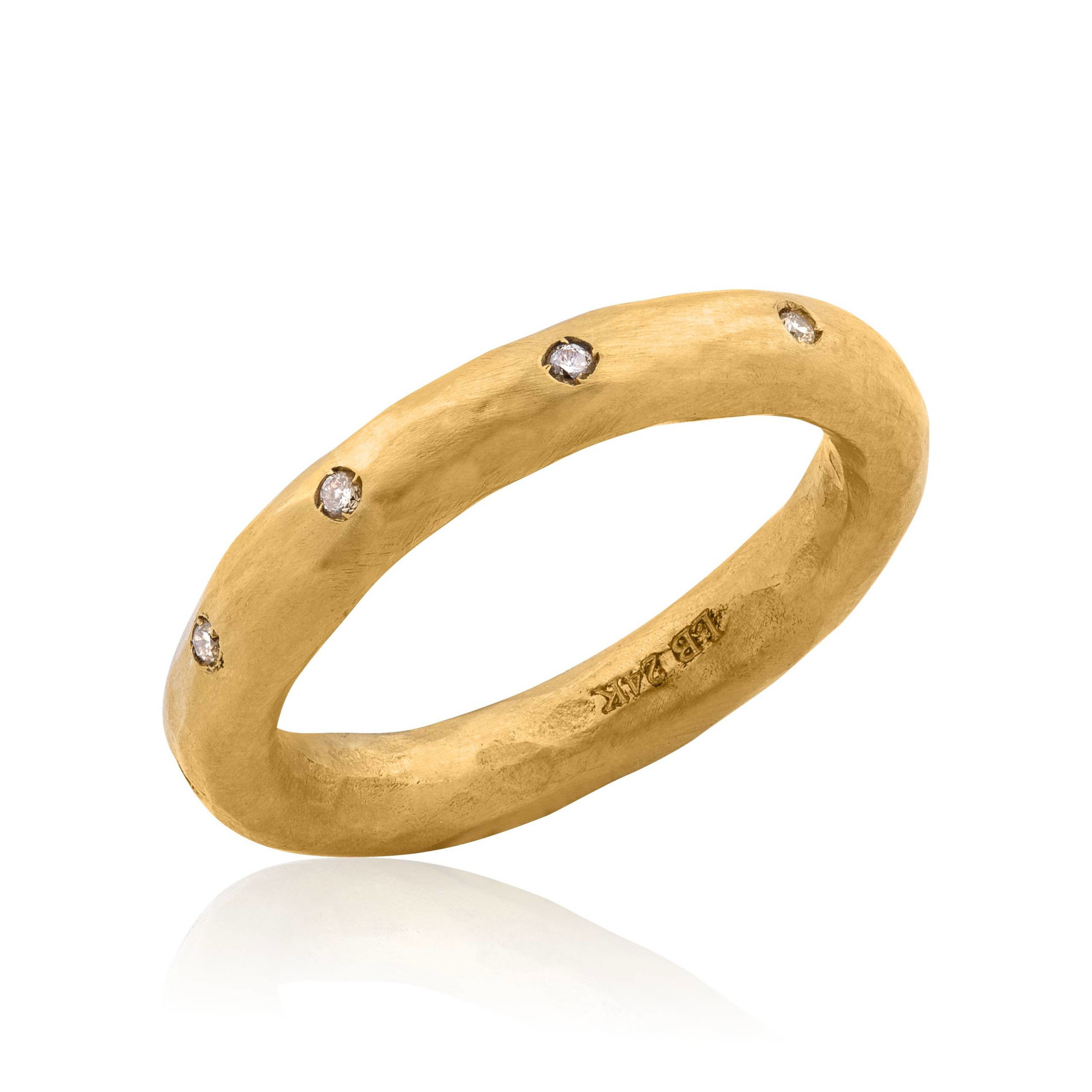 This stunning 24k yellow gold hammered band is adorned with sparkling diamonds. Elevate your style with this luxurious piece today and enjoy timeless elegance that’s perfect for any occasion.-24k Yellow gold-Round diamonds, 0.10ctsItem# 002-804-00554 Yellow Gold Band with Diamonds