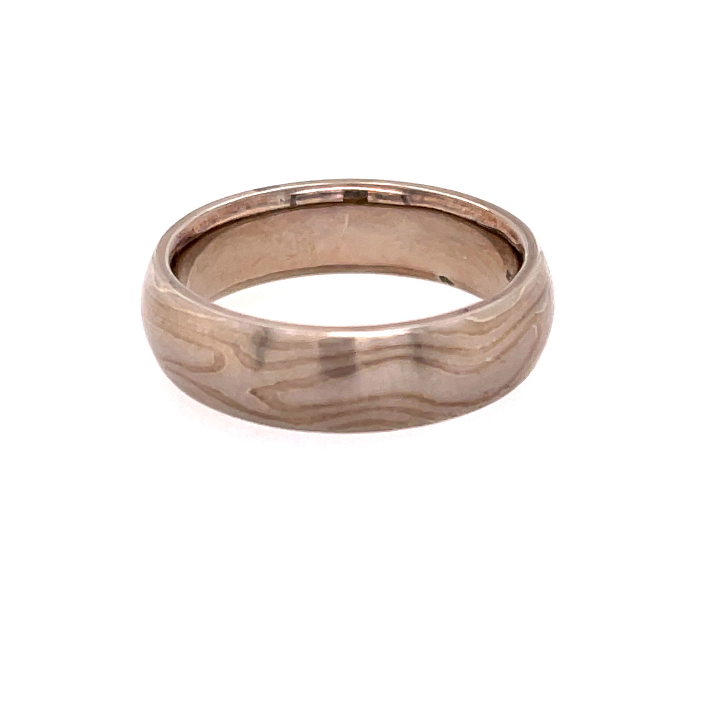 This domed band in sterling silver and palladium features an elegant Mokume Gane River Pattern, flowing seamlessly around the ring in rich, layered tones. A perfect blend of artistry and tradition, it offers a unique, organic look for those who appreciate exceptional craftsmanship.-Sterling Silver and Palladium-6mm-Size 9.5, Contact for sizing optionsItem# 405-00052 Mokume Gane River Band