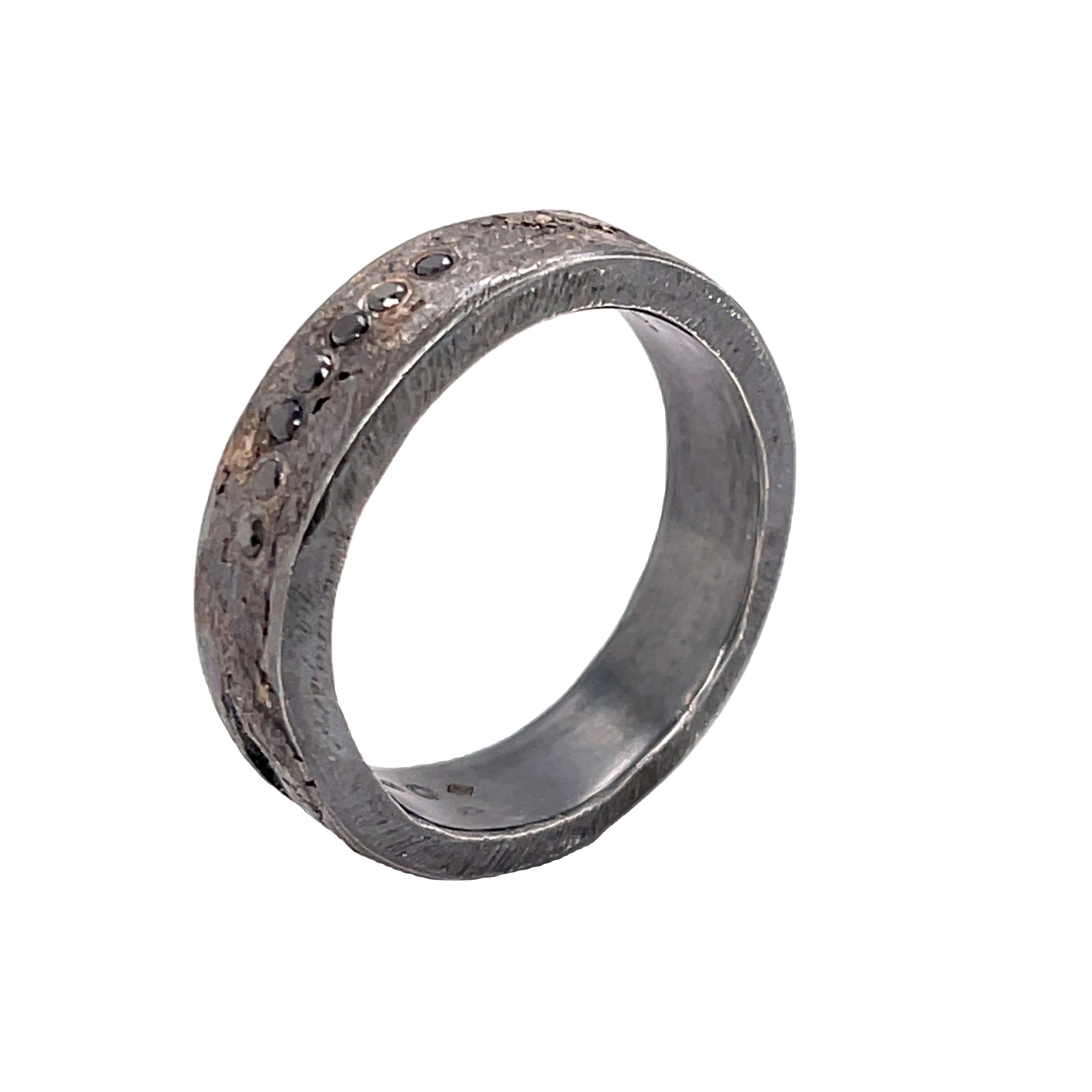This distinctive men’s band pairs palladium and sterling silver in an organic, sculptural form, accented by striking black diamonds. Bold and unconventional, it’s a design that celebrates individuality with understated edge.-Palladium and Sterling Silver-Round black diamonds, 0.16cts-Size 9.5, Contact for sizing optionsItem# 405-00111 Black Diamond Organic Men's Band