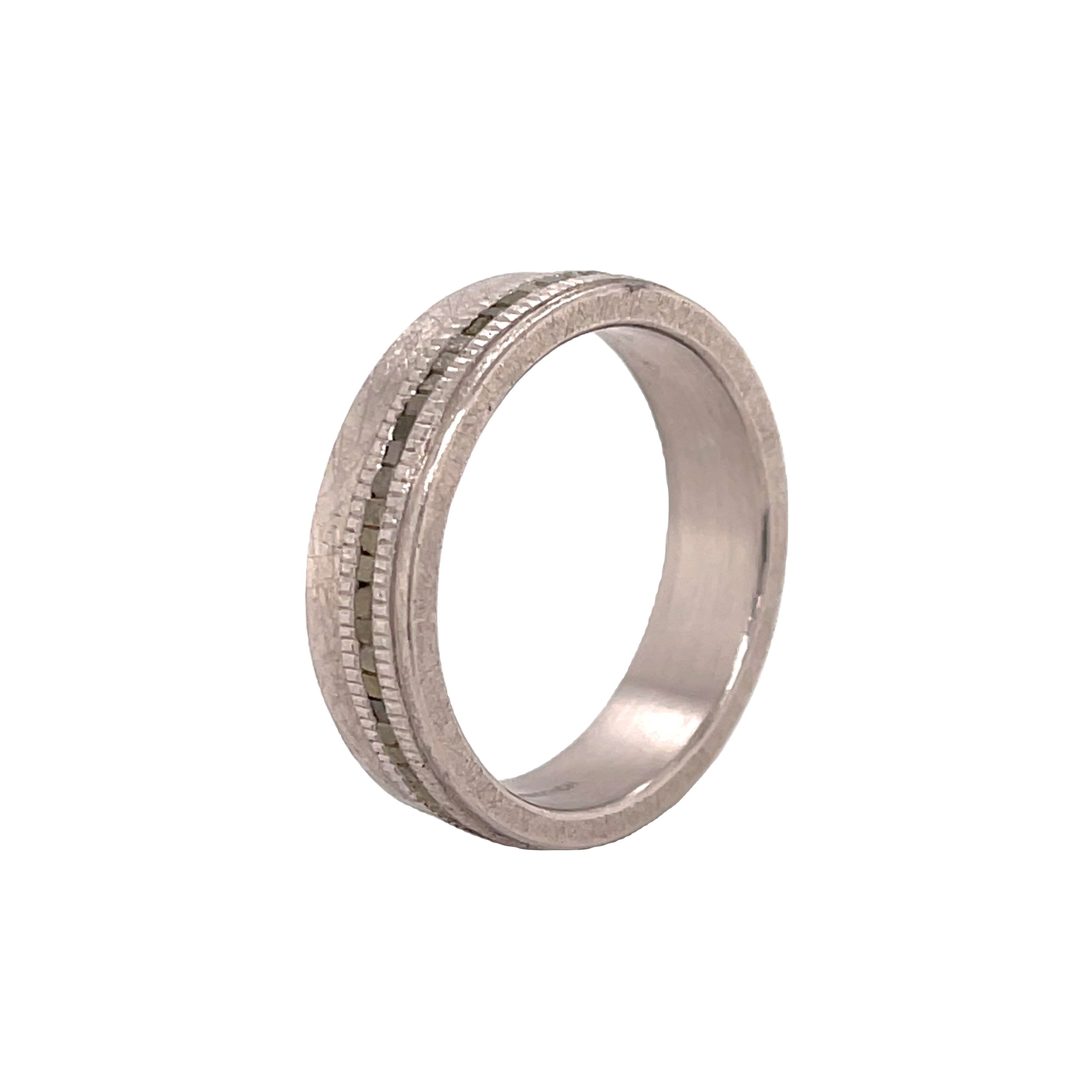 This flat profile eternity band features raw diamonds in a continuous row, offering a natural, unrefined brilliance. Finished with a coined edge on each side, the design adds texture and character to this modern yet timeless piece.-Palladium-Cubed raw diamonds, 0.74cts-6m-Size 10, Contact for sizing options Item# 115-00002 Raw Diamond Men's Eternity Band