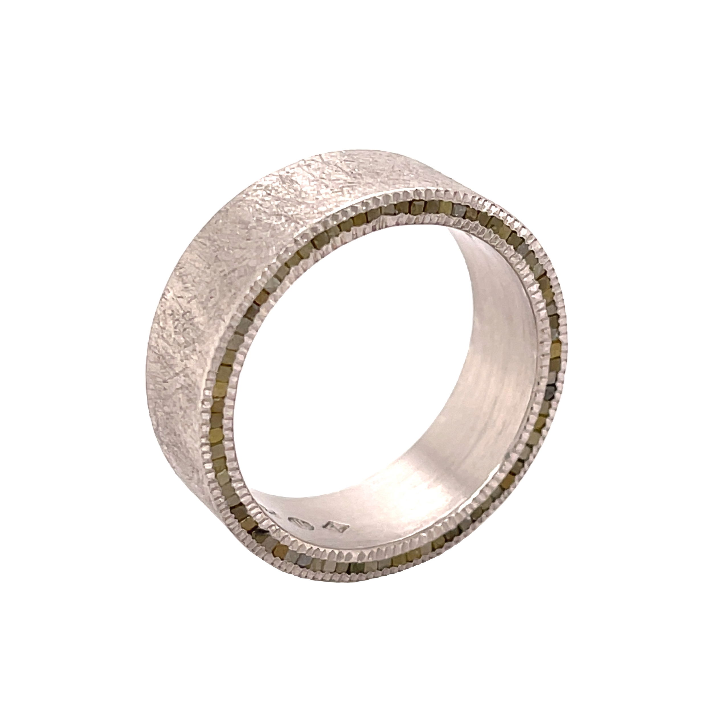This flat-profile band offers a modern twist with raw diamonds set into one side, creating an understated yet distinctive edge. The asymmetrical design highlights the natural beauty of the stones, making it a unique piece with effortless style.-Palladium-Cubed raw diamonds, 0.61cts-8mm-Size 10, Contact for sizing optionsItem# 115-00001 Raw Diamond Men's Eternity Band