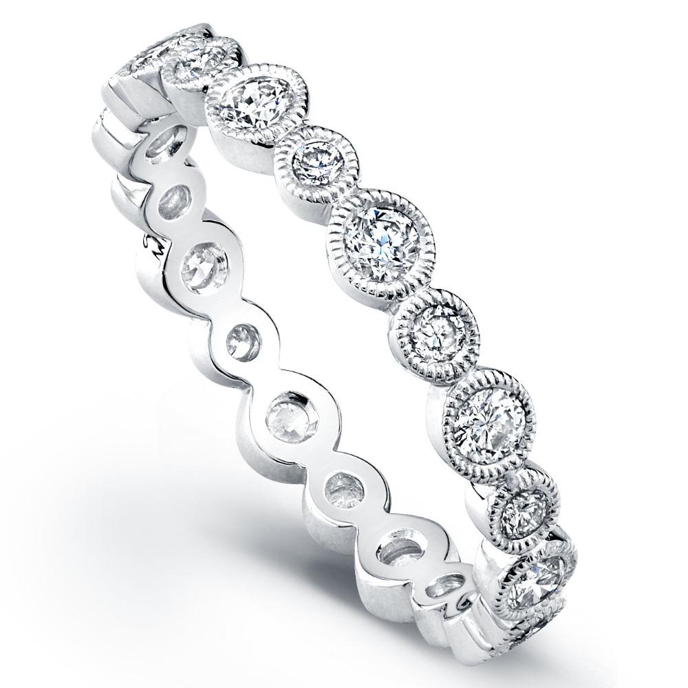 This 18K white gold eternity band features round diamonds in alternating sizes, each set in a sleek bezel with a milgrain detail. A modern yet timeless design that offers subtle sparkle and sophisticated style.-18k White gold-Round diamonds, 0.71cts-Size 6.5, Contact for sizing optionsItem# 120-00095 Bezel Eternity Band