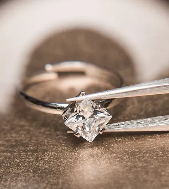 Jewelry appraisal being performed with a loupe